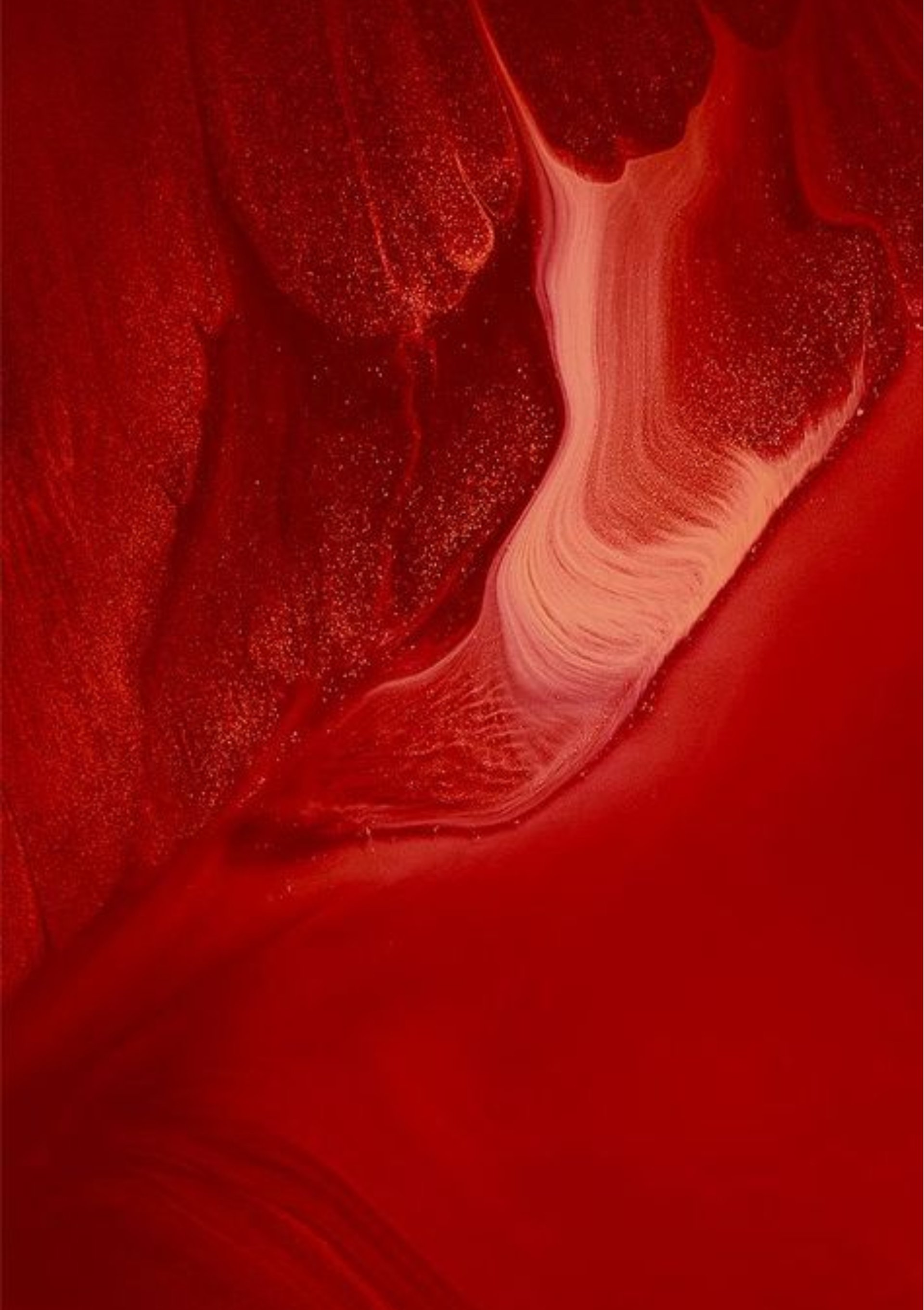 woman in gray sweater holding lipstick