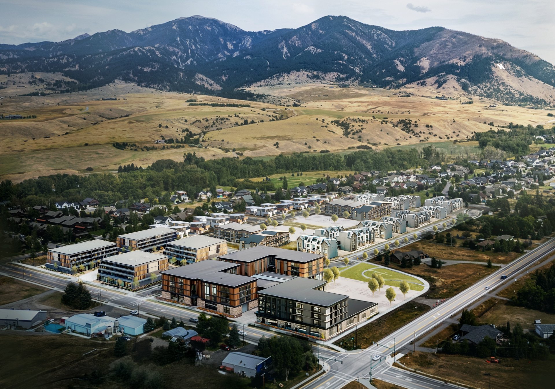 green grass field near mountain under white clouds during daytime