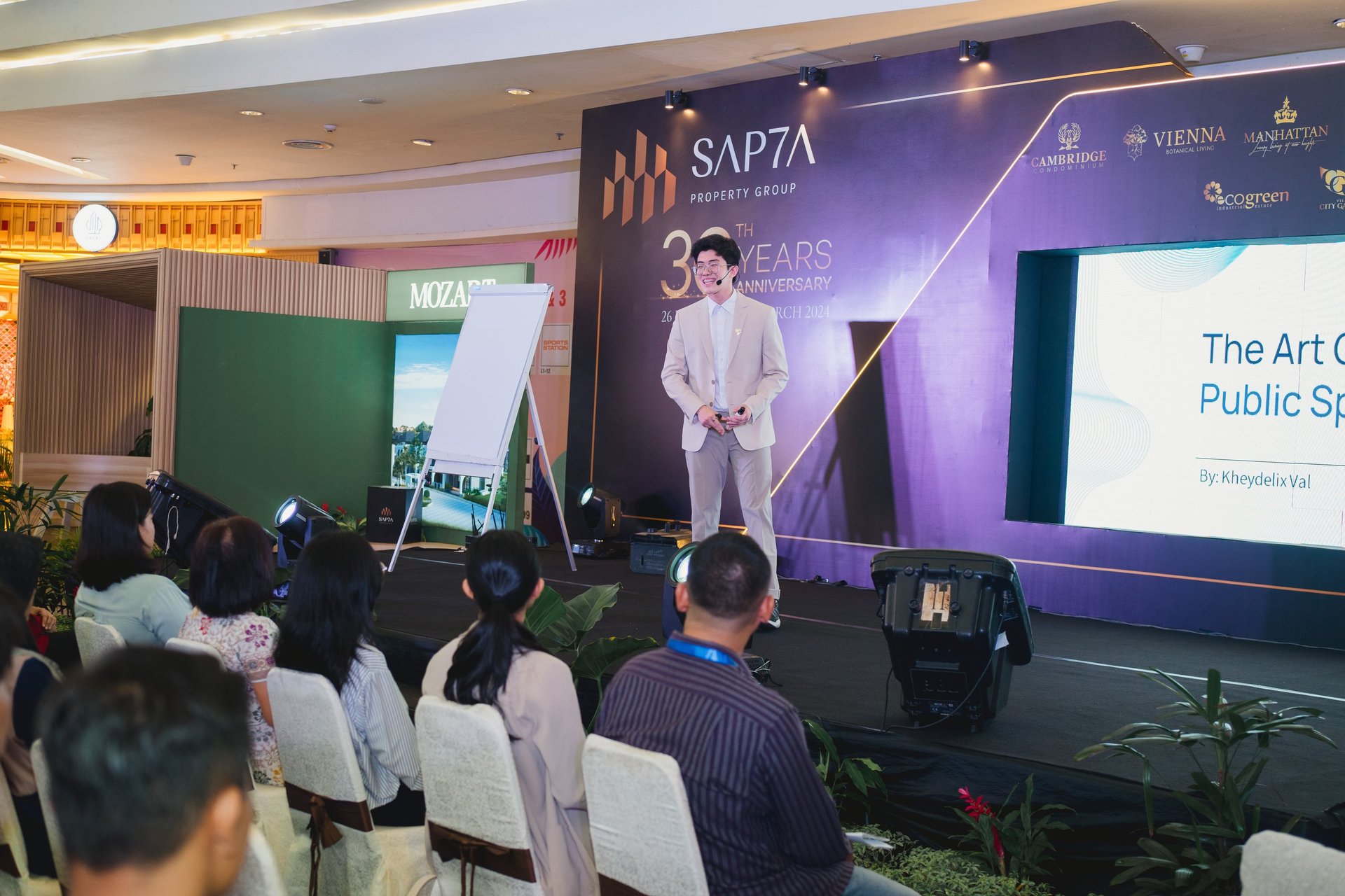 a woman standing in front of a crowd holding a microphone