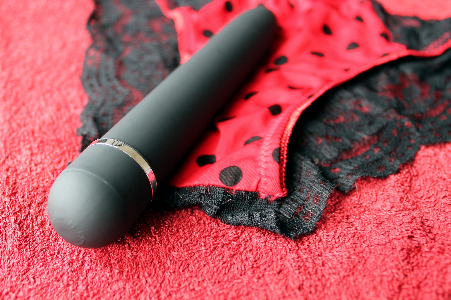 a vibrator and panties on red canvas