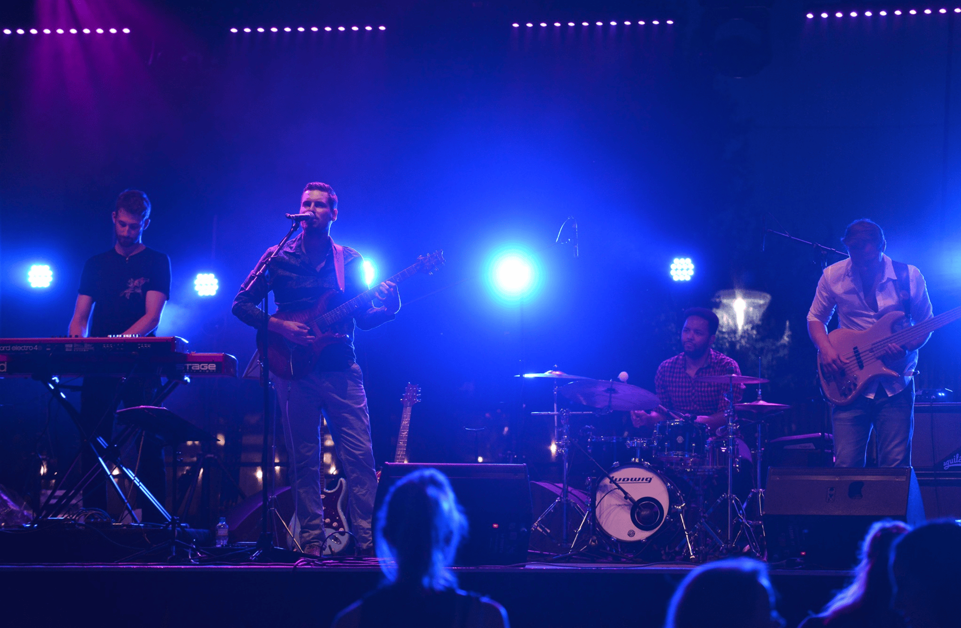 grayscale photo of band performing on stage