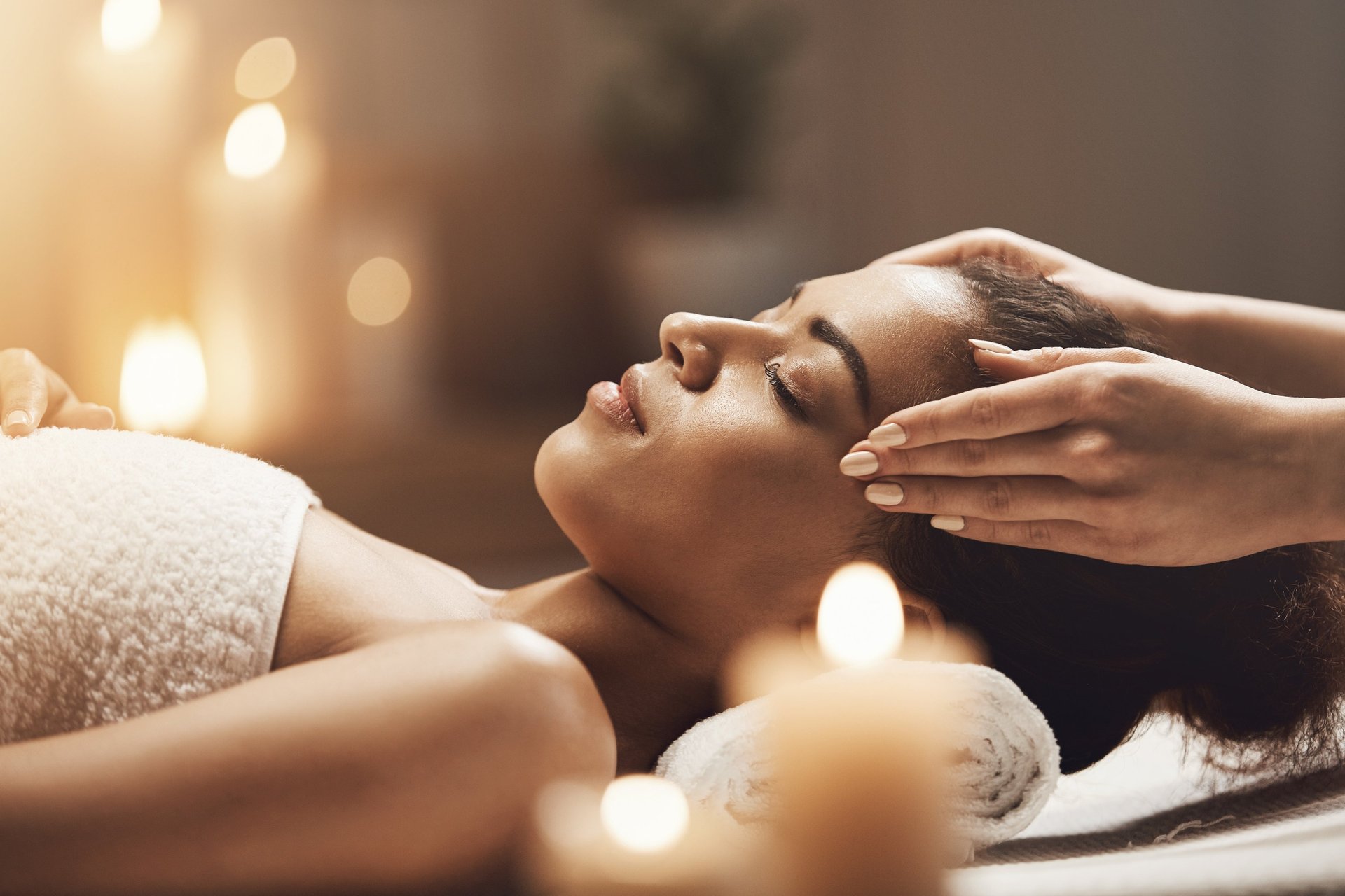 a woman getting a facial massage on her face