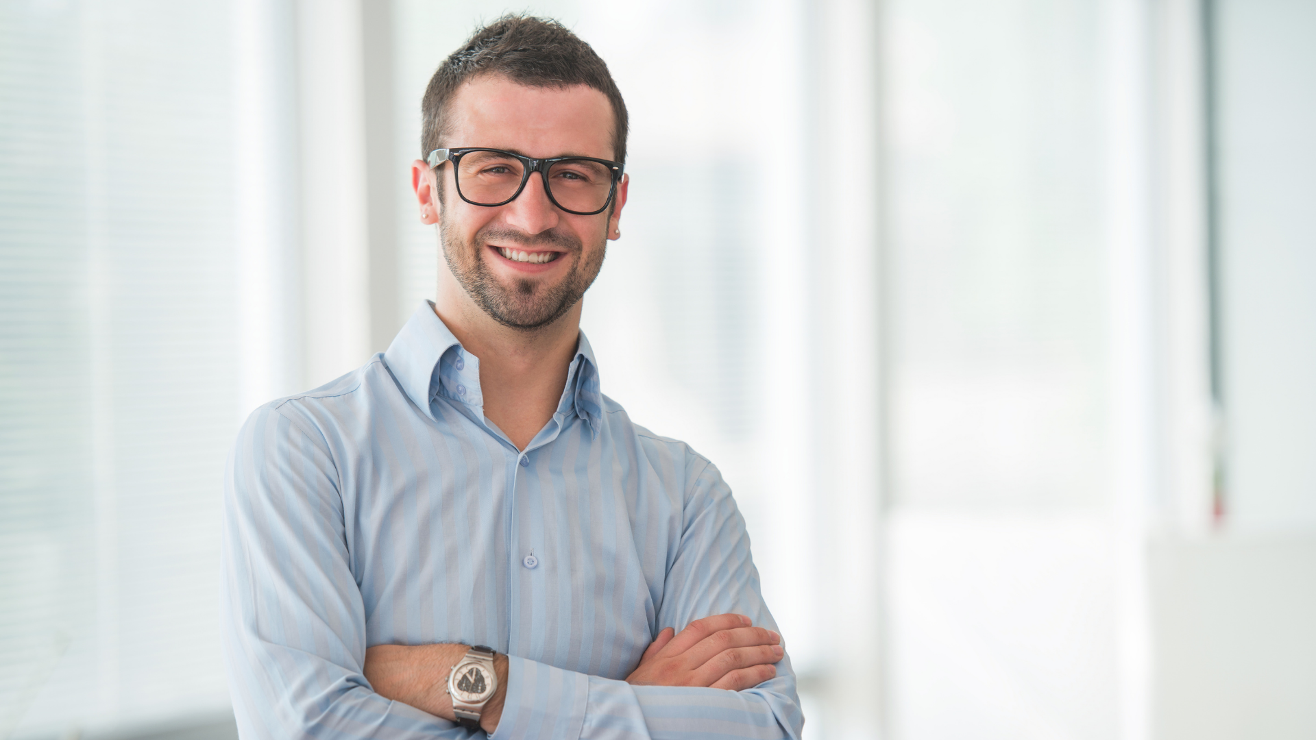 close up of man wearing glasses in business attire smiling