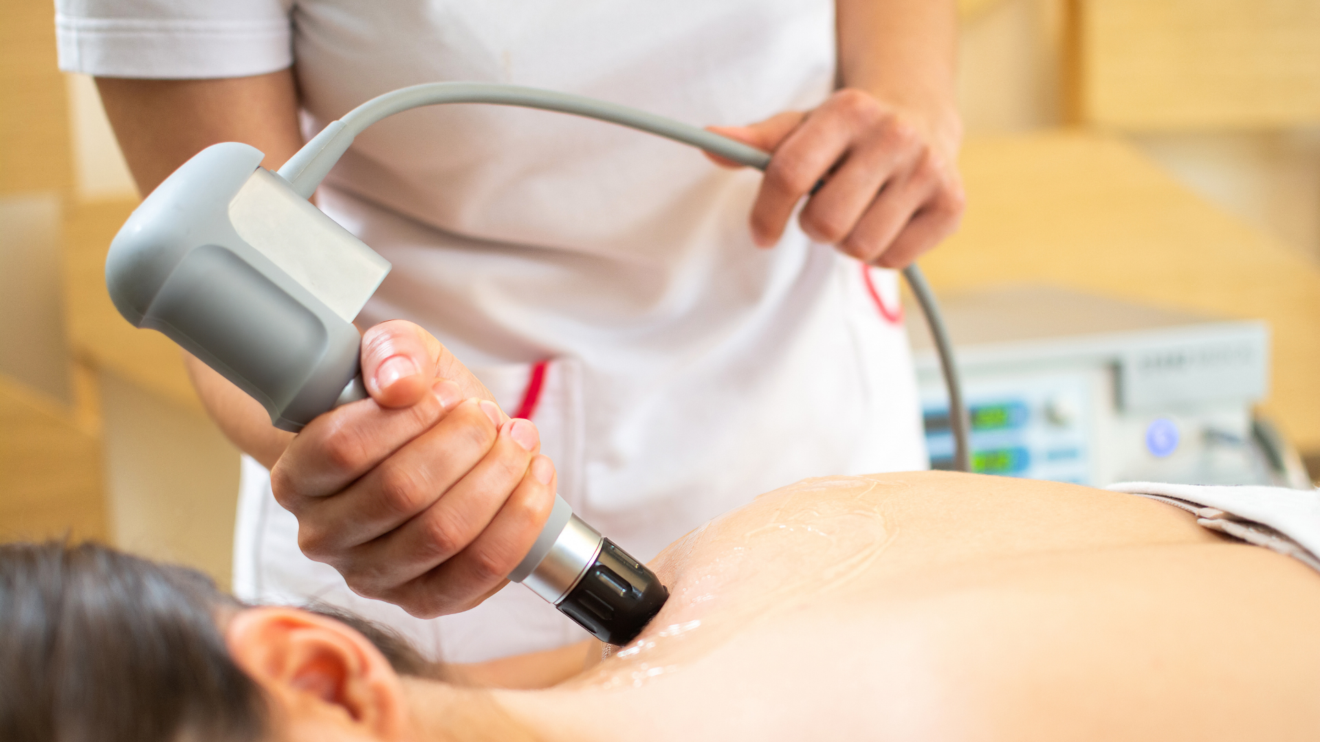 close up of woman getting shockwave therapy on the upper back