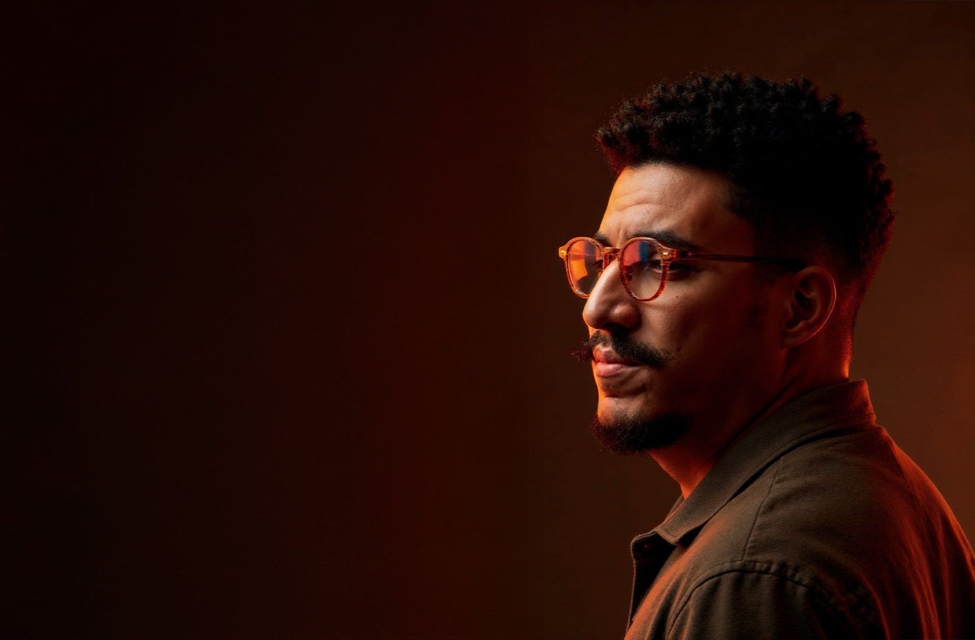 an abstract photo of a curved building with a blue sky in the background