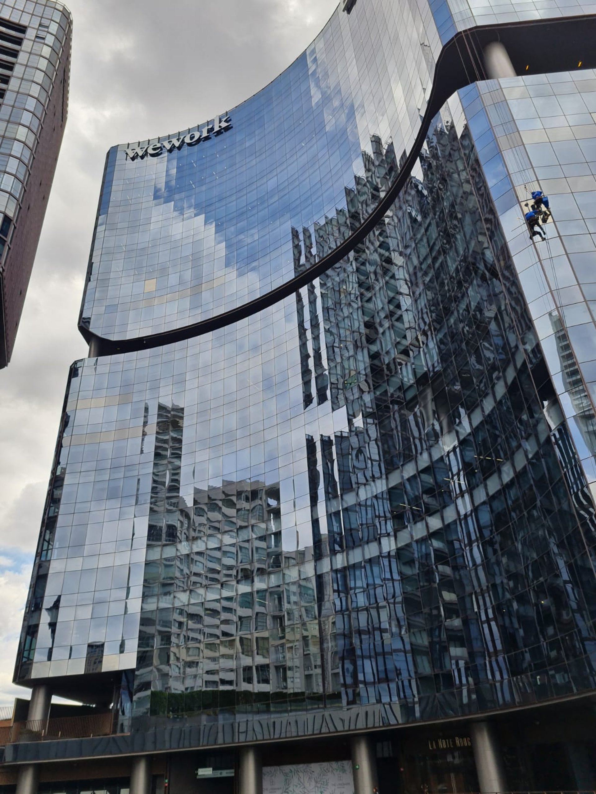 an abstract photo of a curved building with a blue sky in the background