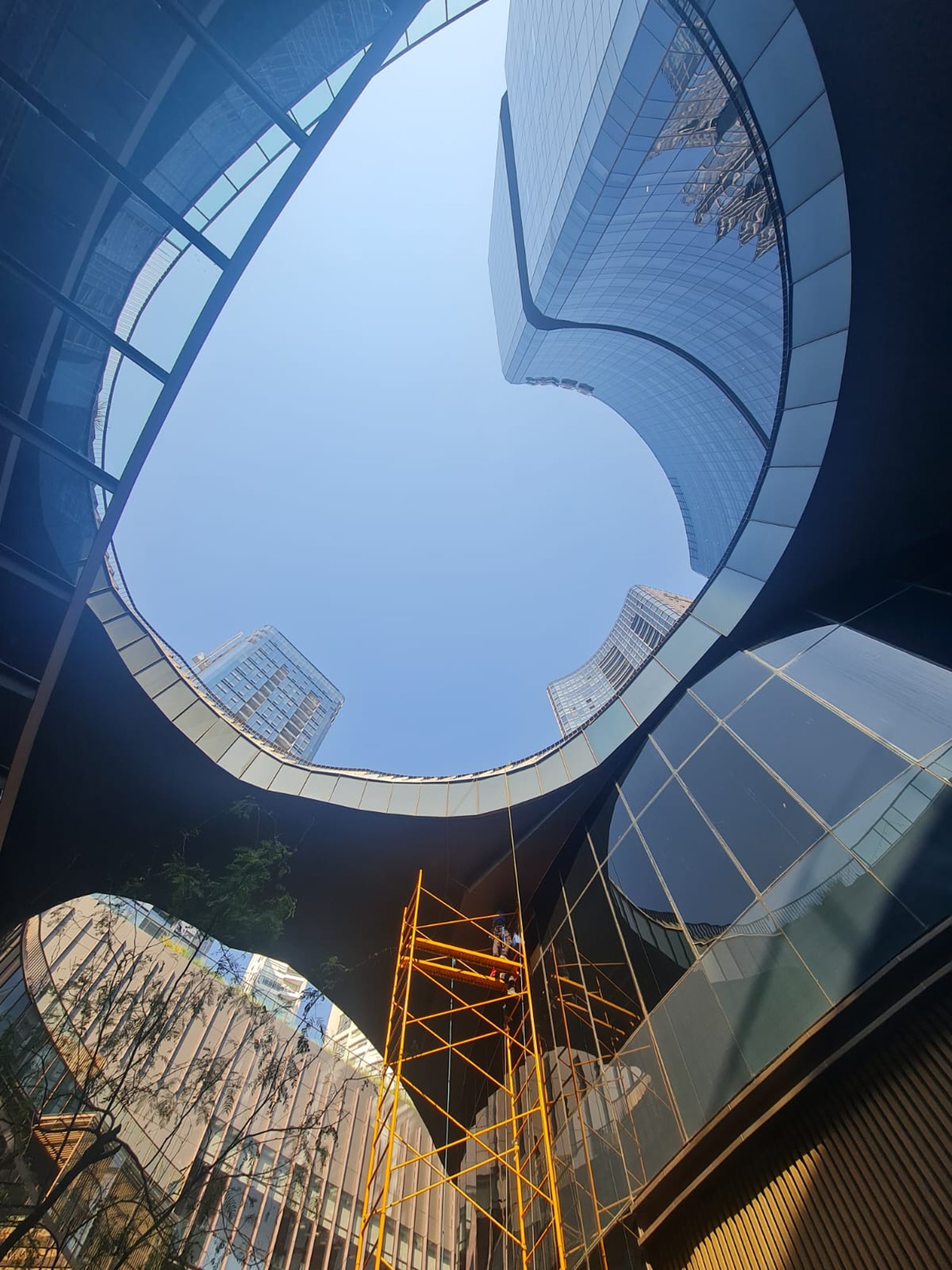 an abstract photo of a curved building with a blue sky in the background