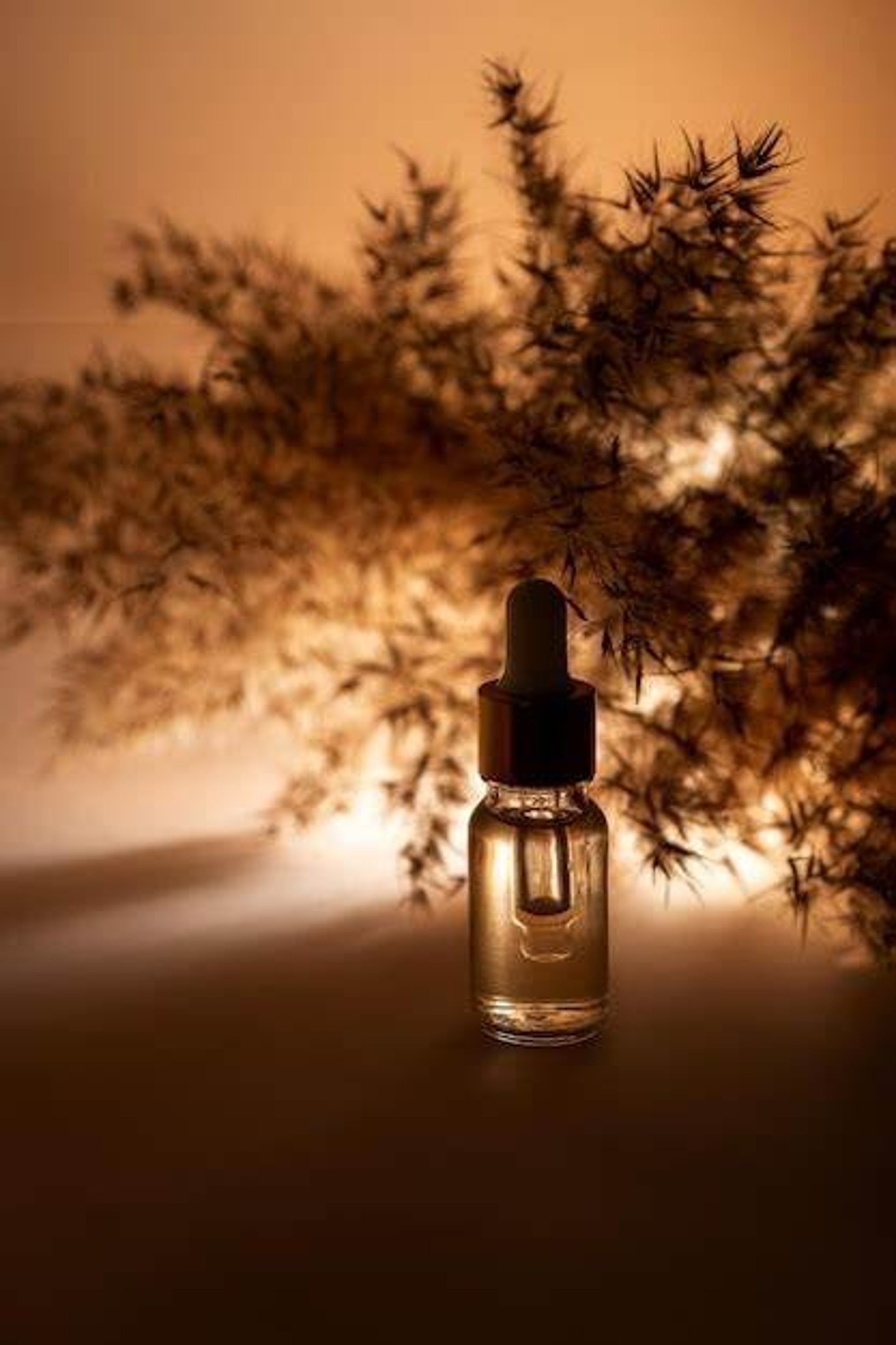 a bottle of essential oil sitting on a table