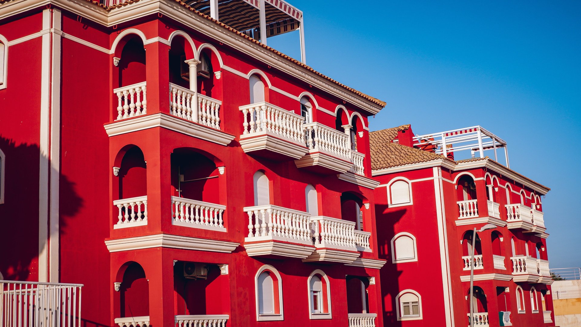 a very tall red building with lots of windows