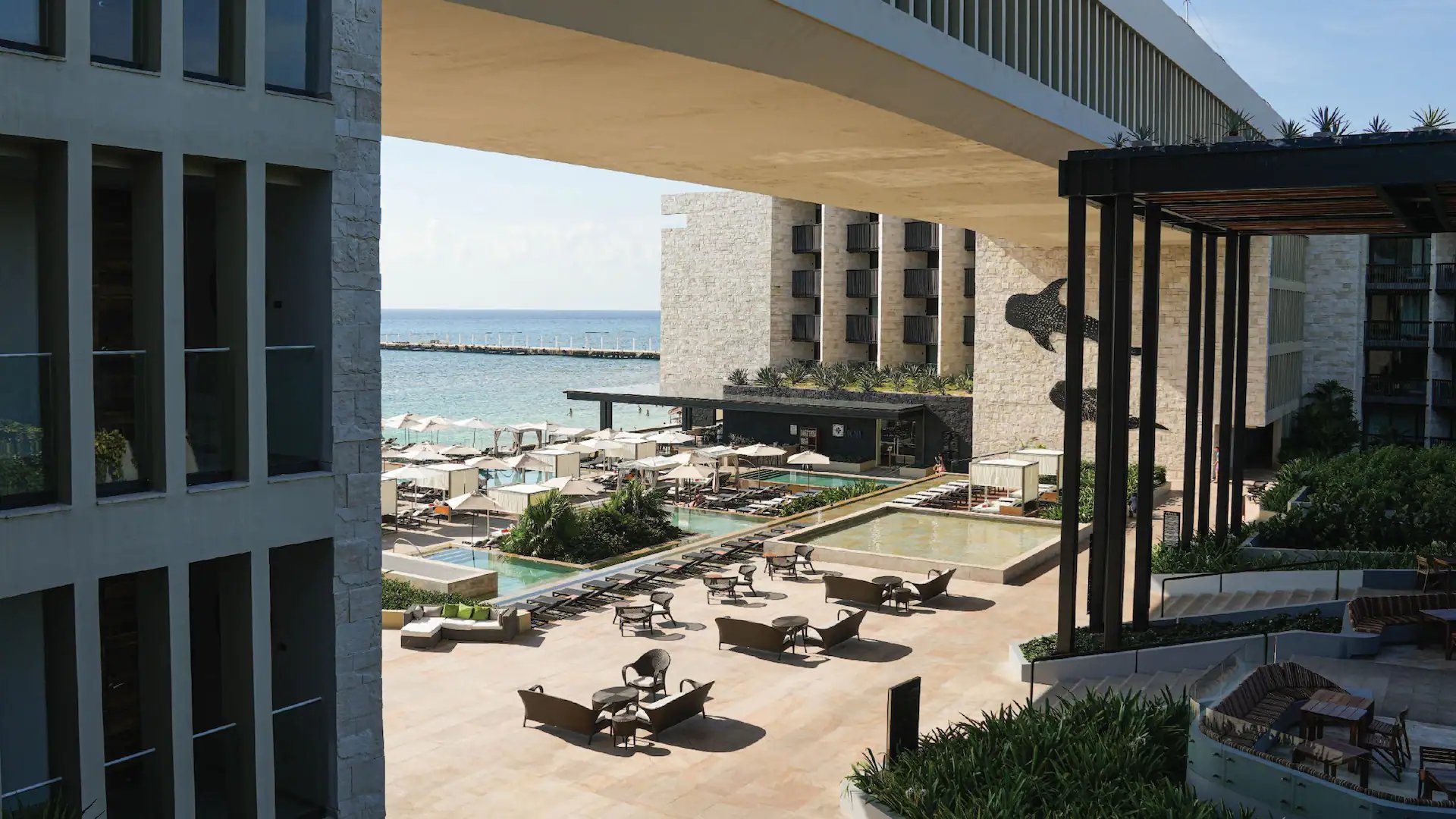 brown wooden table near swimming pool