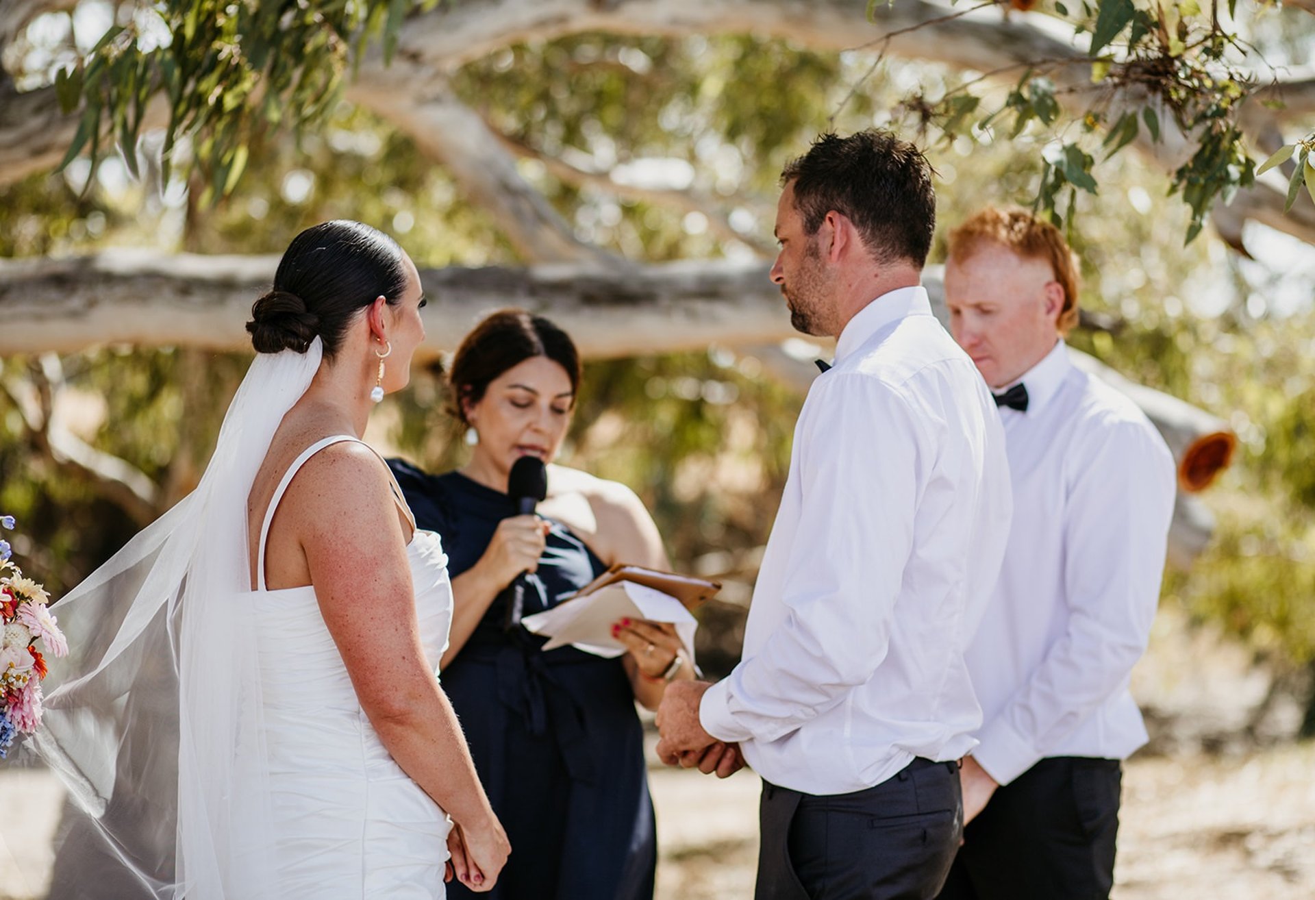 Bride and groom exchanging vows during their Noosa private property wedding ceremony