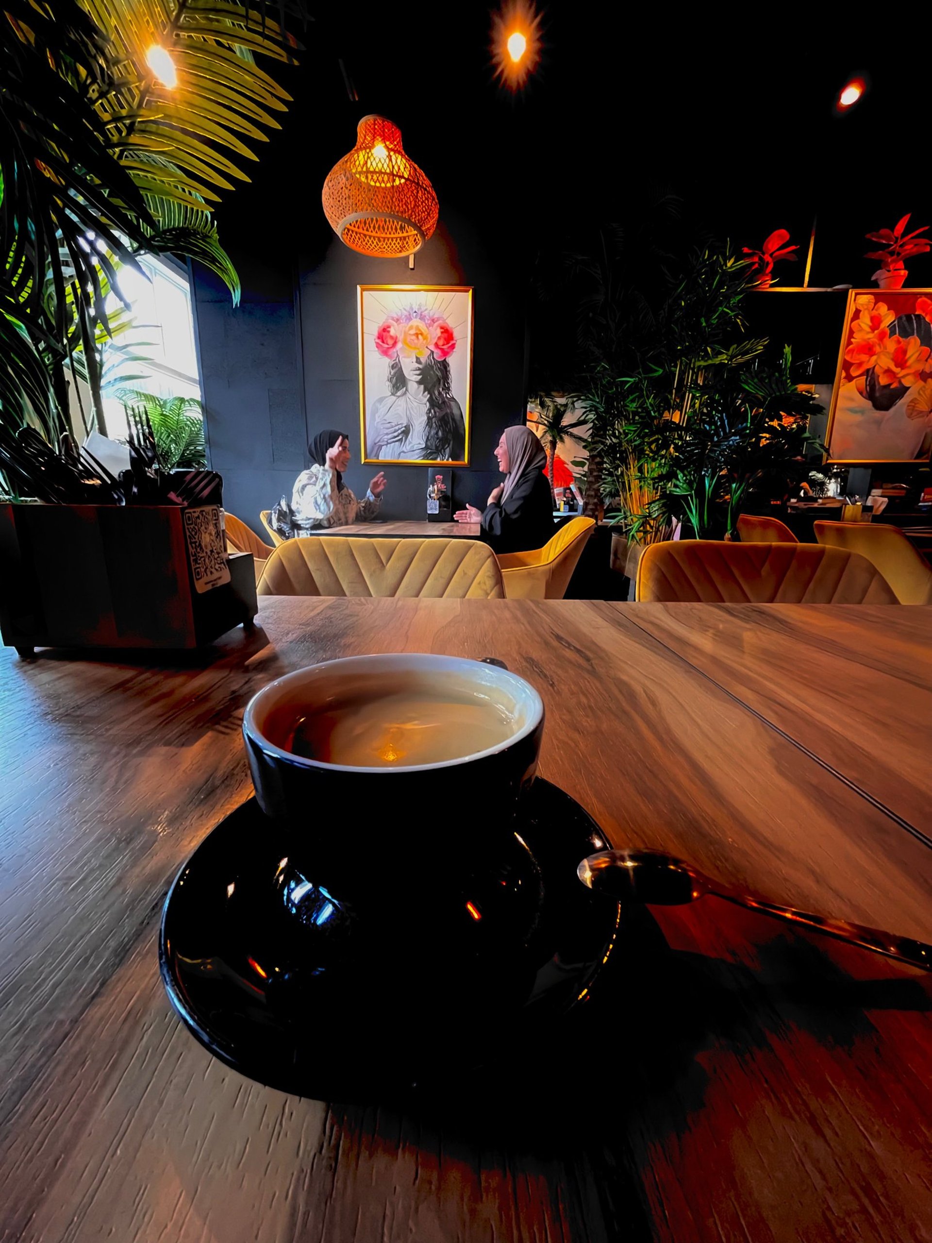 a stork sitting on top of a nest on top of a telephone pole