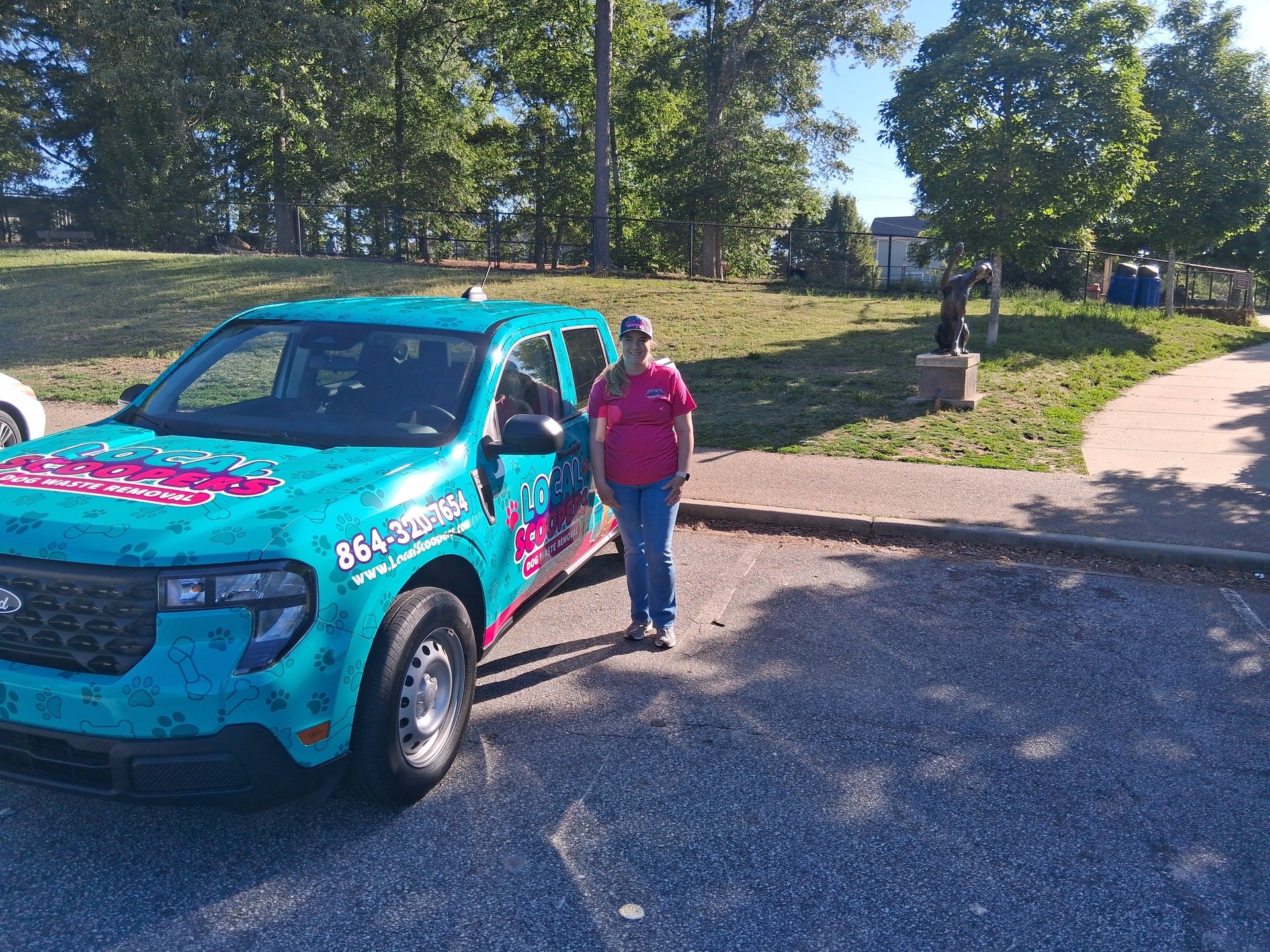 Owner Amanda Bailey standing in front of a Local Scoopers service truck at Conestee Park in Mauldin, SC