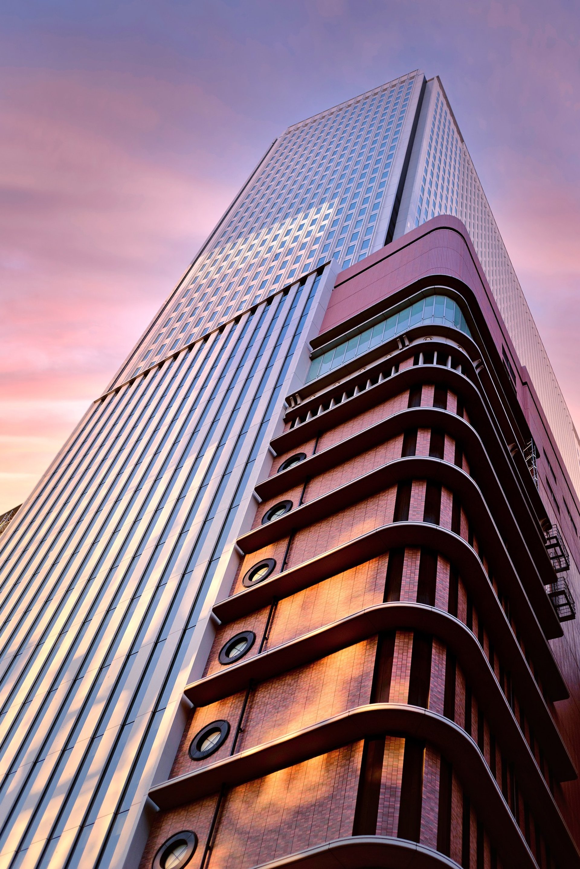 an abstract photo of a curved building with a blue sky in the background