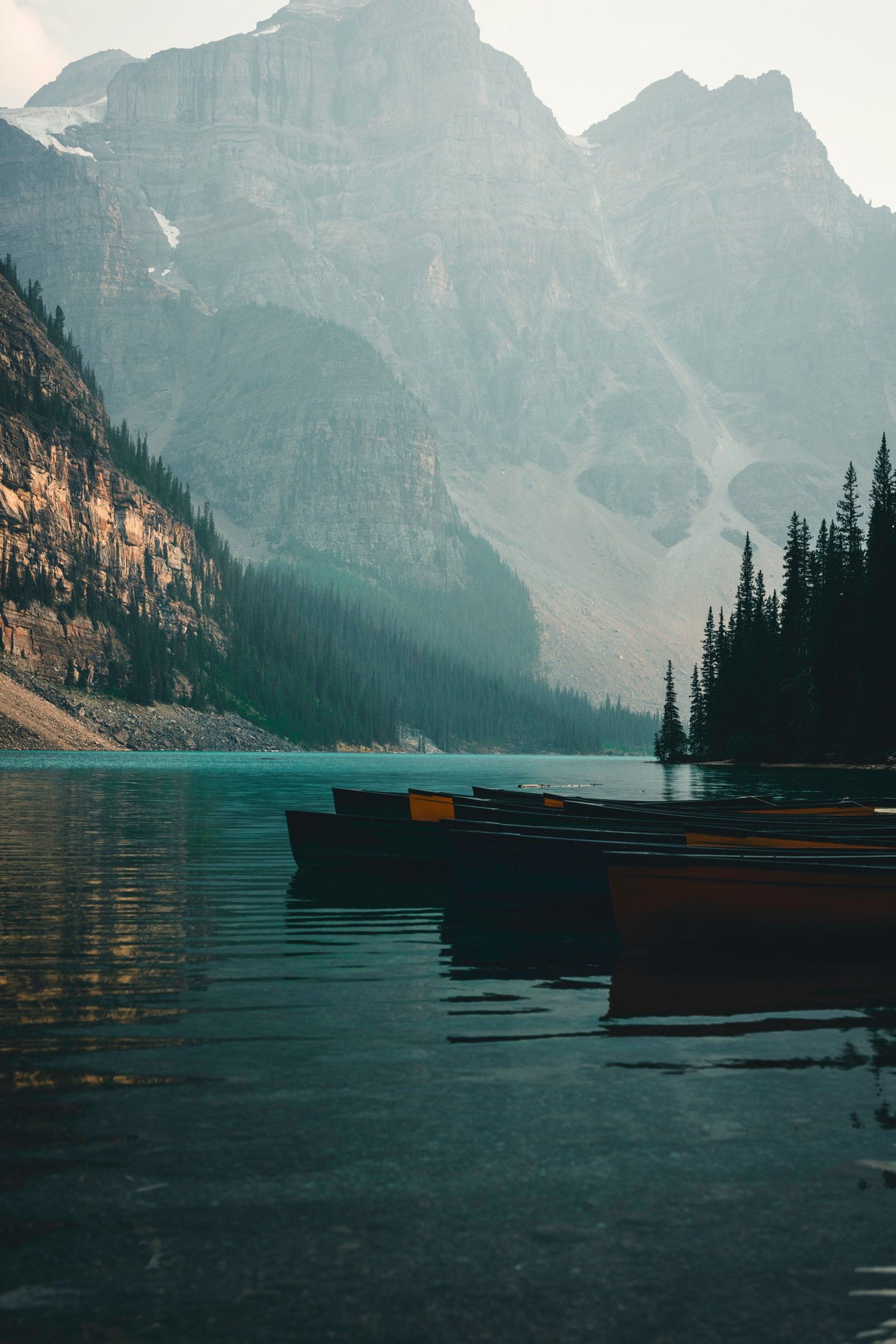 A couple of boats floating on top of a lake