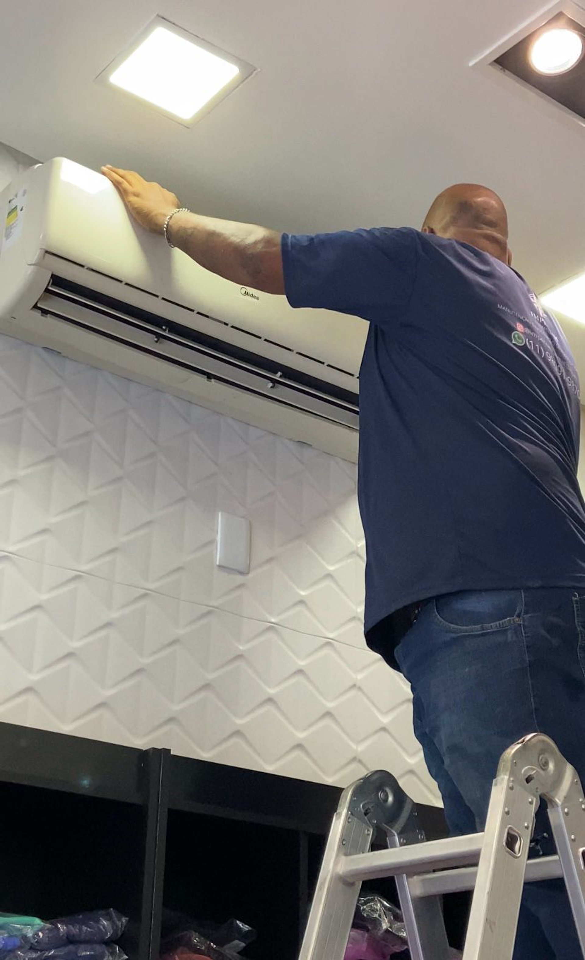 A man sanding a wooden table with a sander