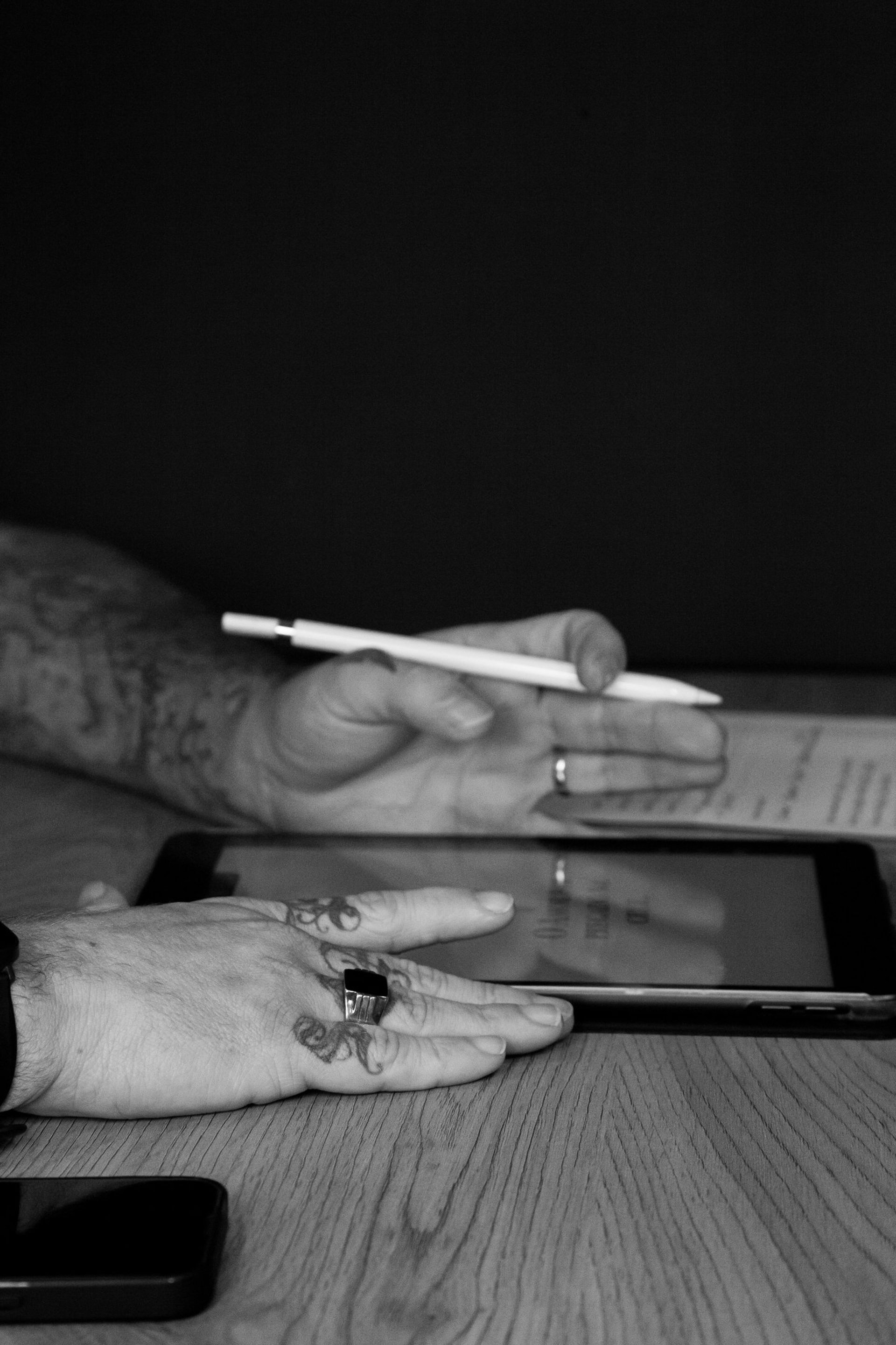 person wearing gold ring holding black textile