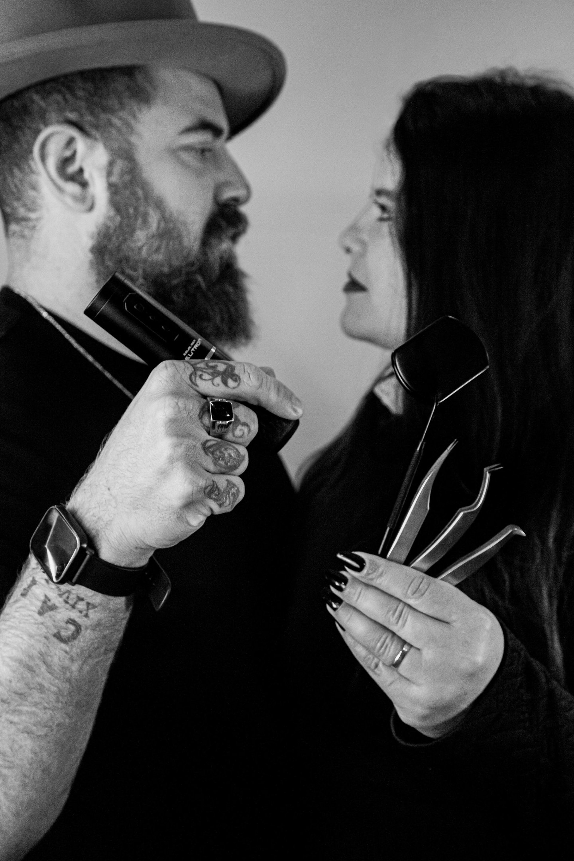 person wearing gold ring holding black textile