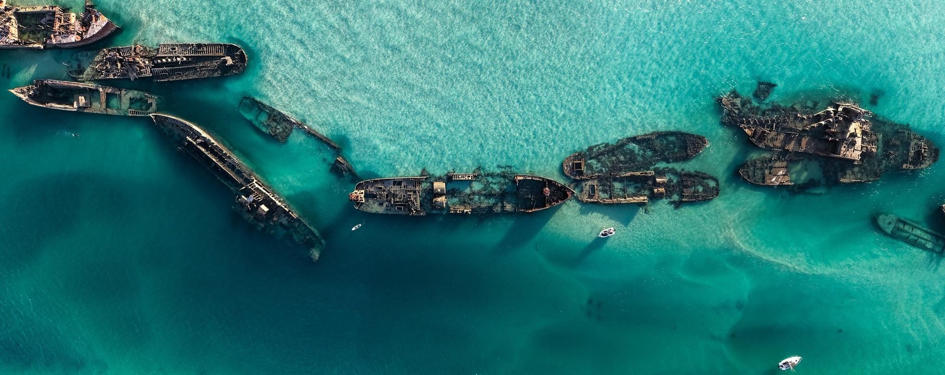 an abstract photo of a curved building with a blue sky in the background