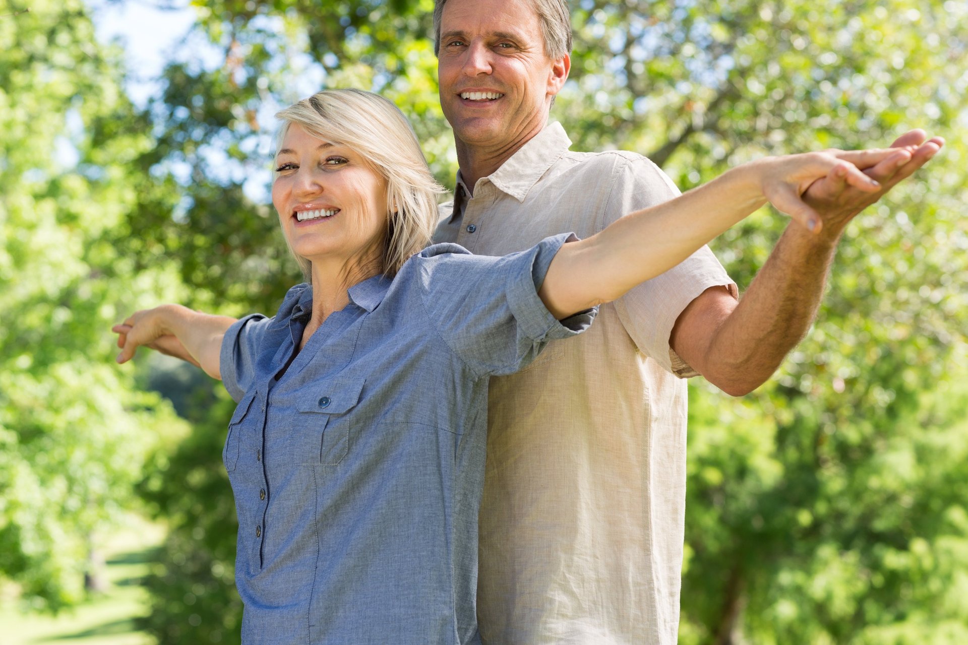 a man and a woman kissing in front of a fountain