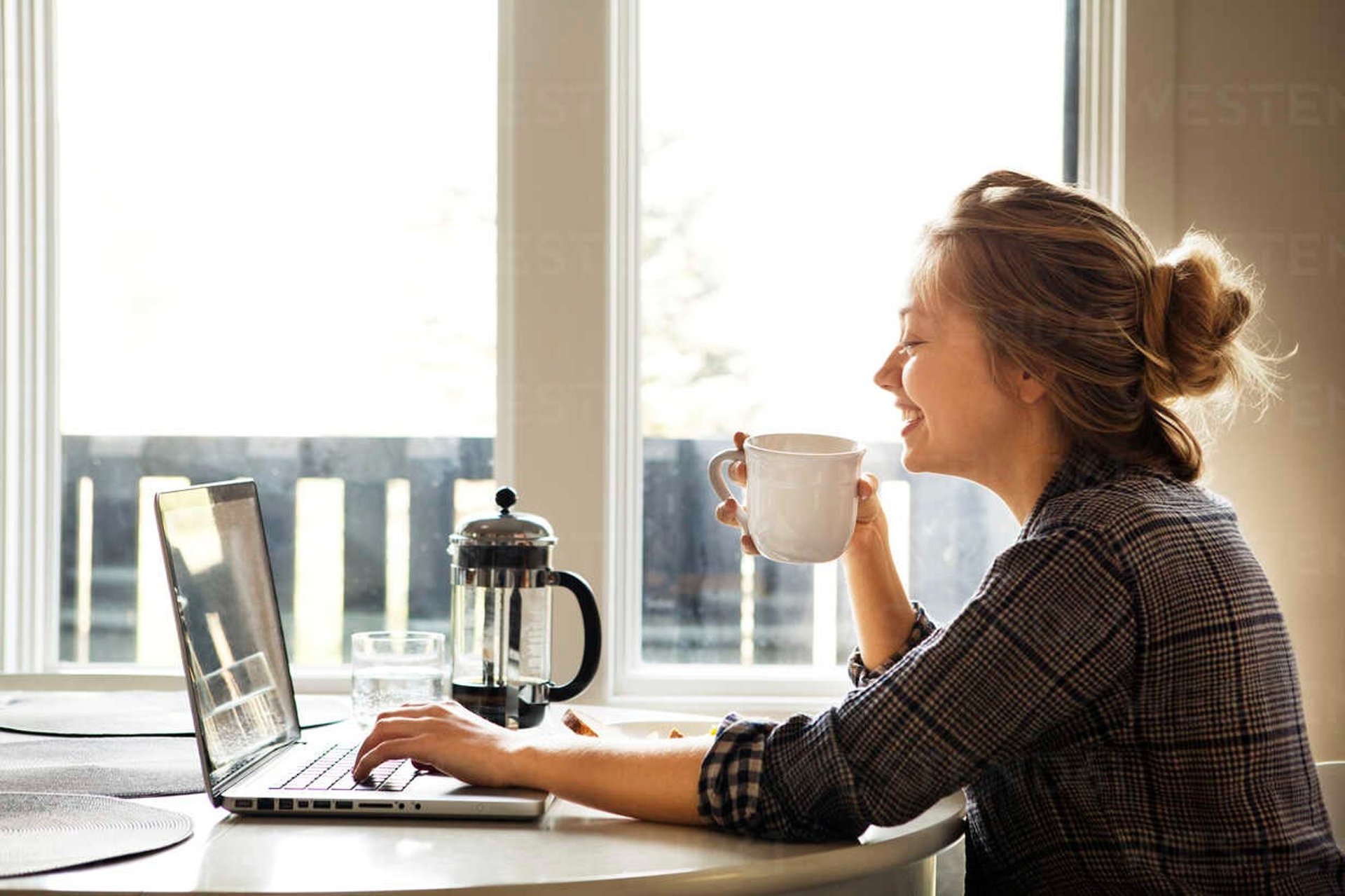 man sitting in front of the MacBook Pro