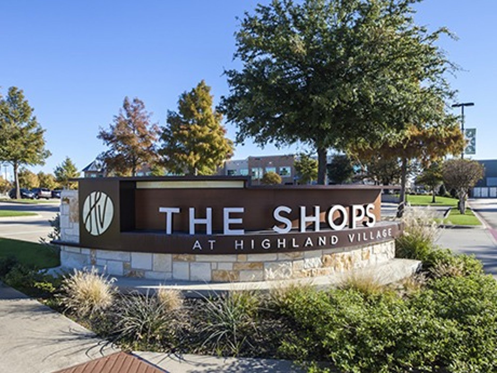 a kitchen counter with a potted plant and a cutting board