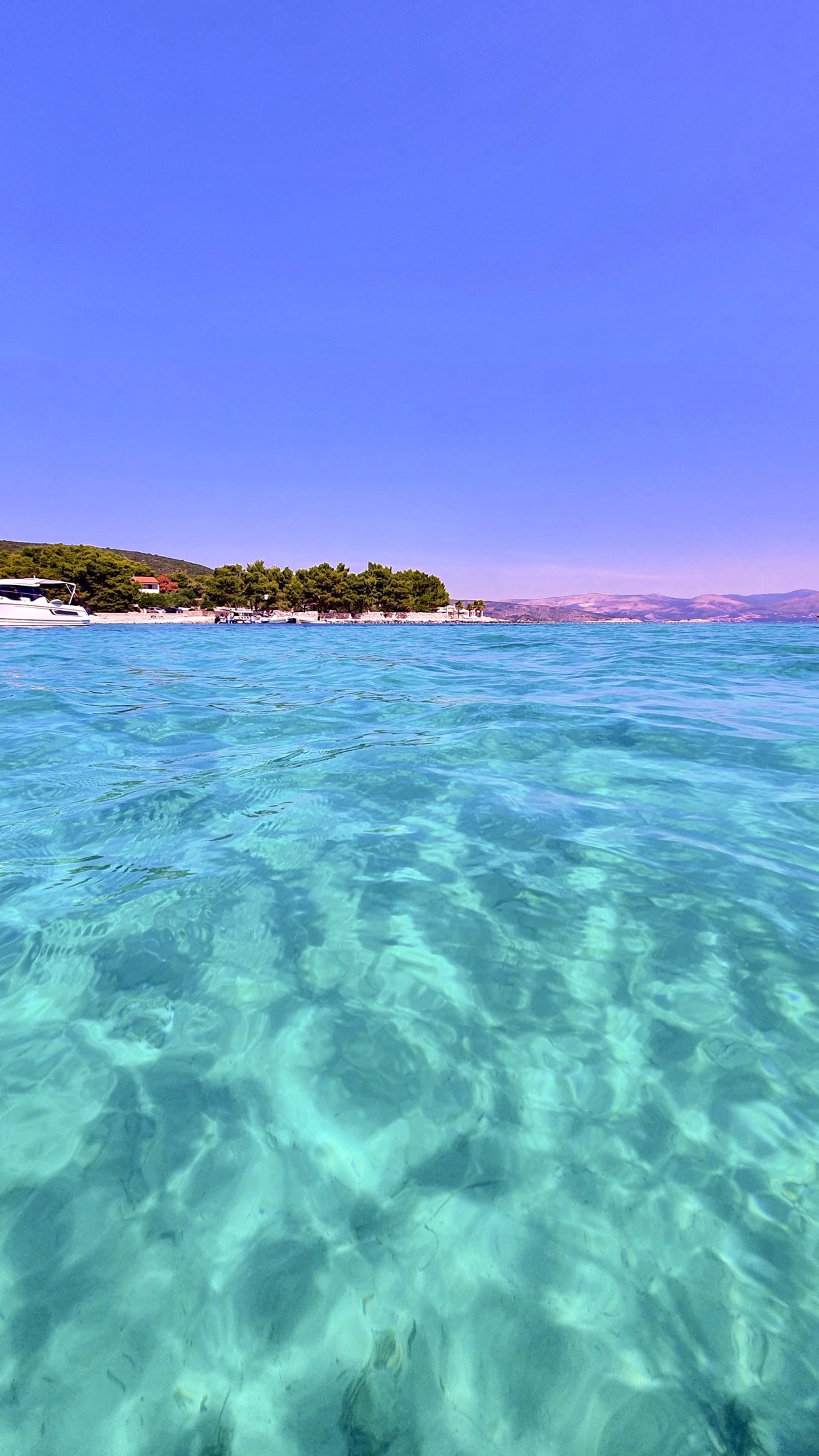 Sea level view of stunning turquoise and crystal-clear sea at Blue Lagoon, Croatia on a private boat tour from Split