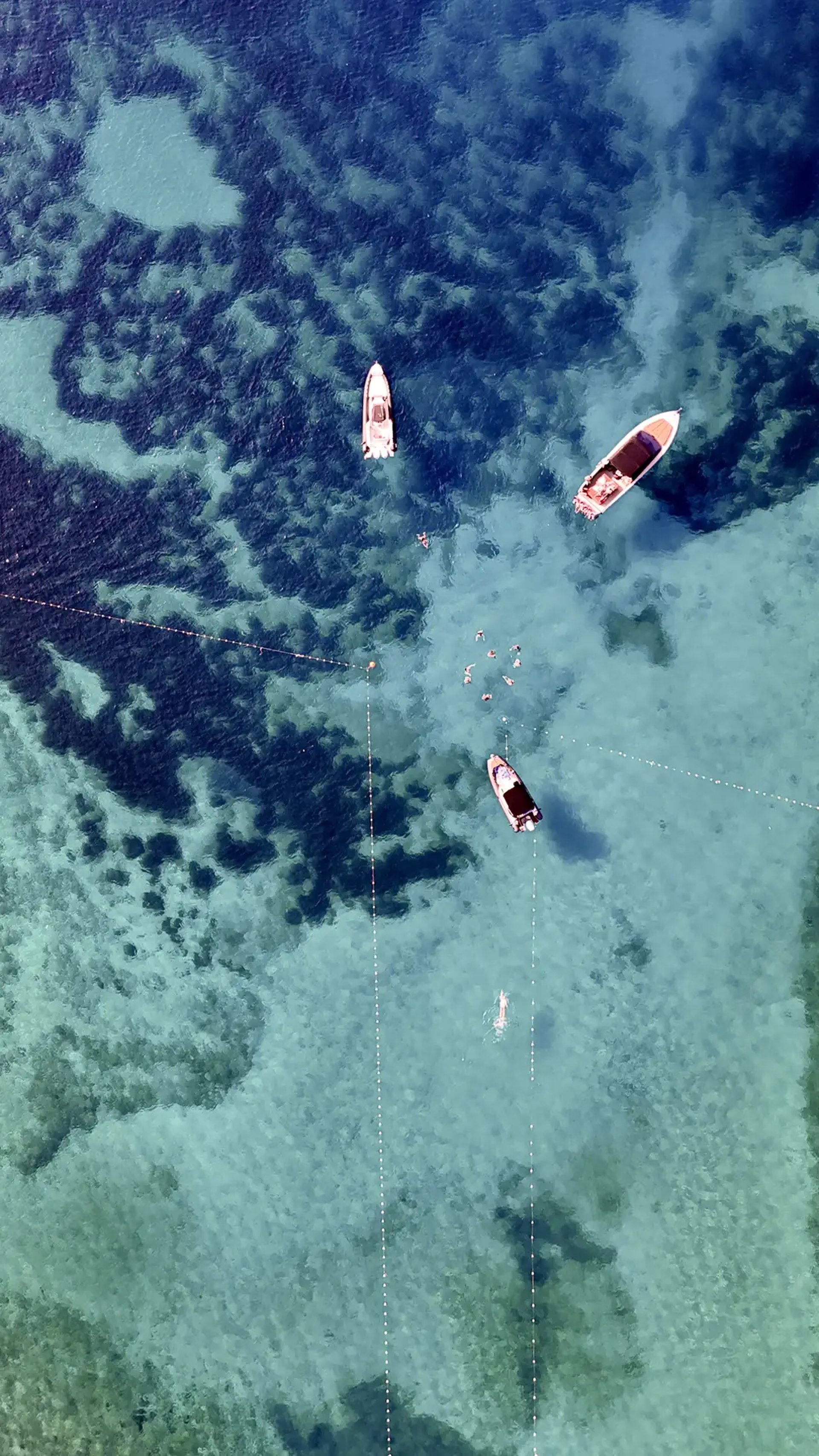 Drone view of crystal clear sea and boats at Pakleni Islands, seen on a private boat tour from Split, Croatia.