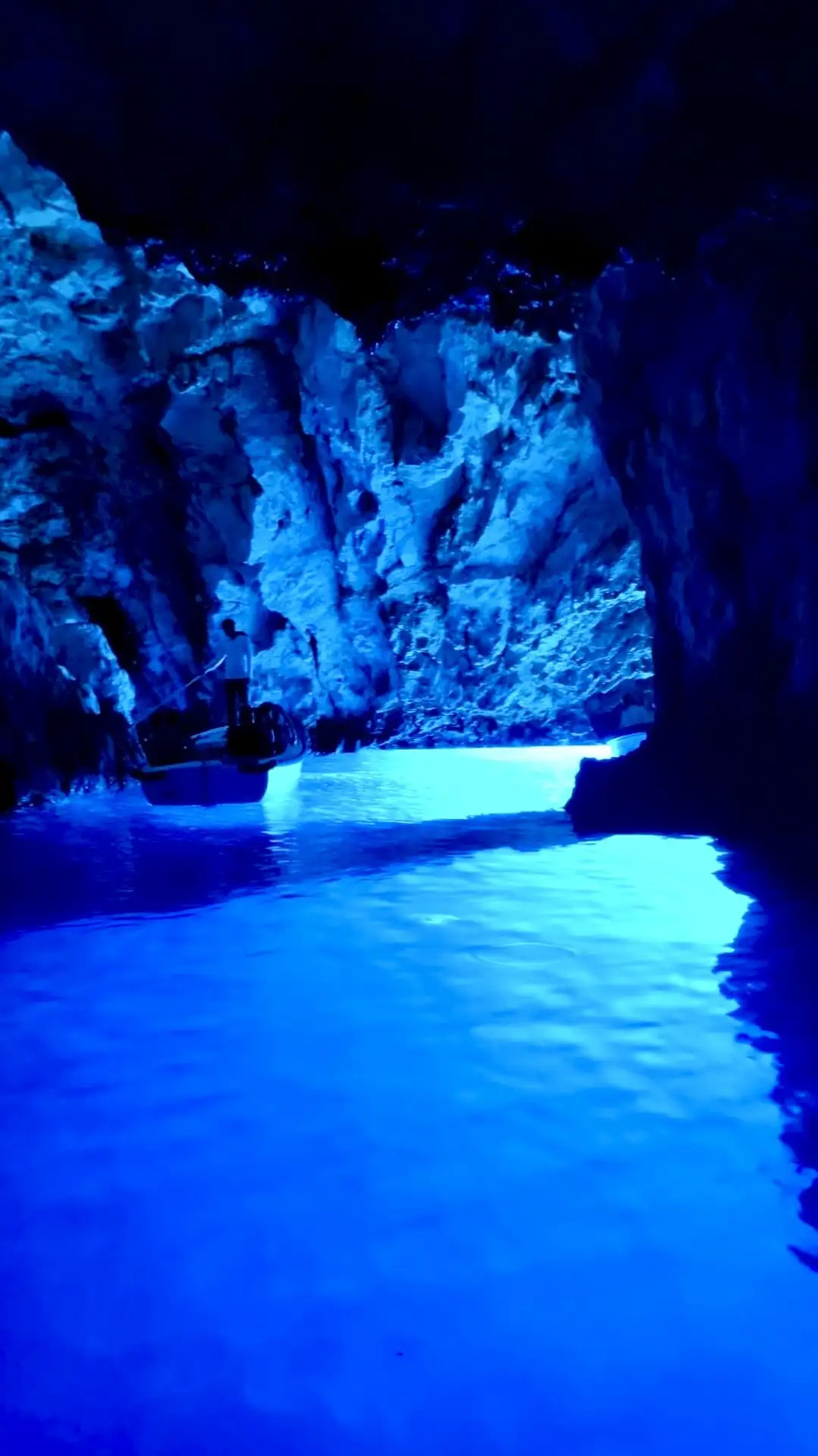 Interior view of the Blue Cave on Bisevo Island, Croatia, showcasing the vibrant glowing blue waters