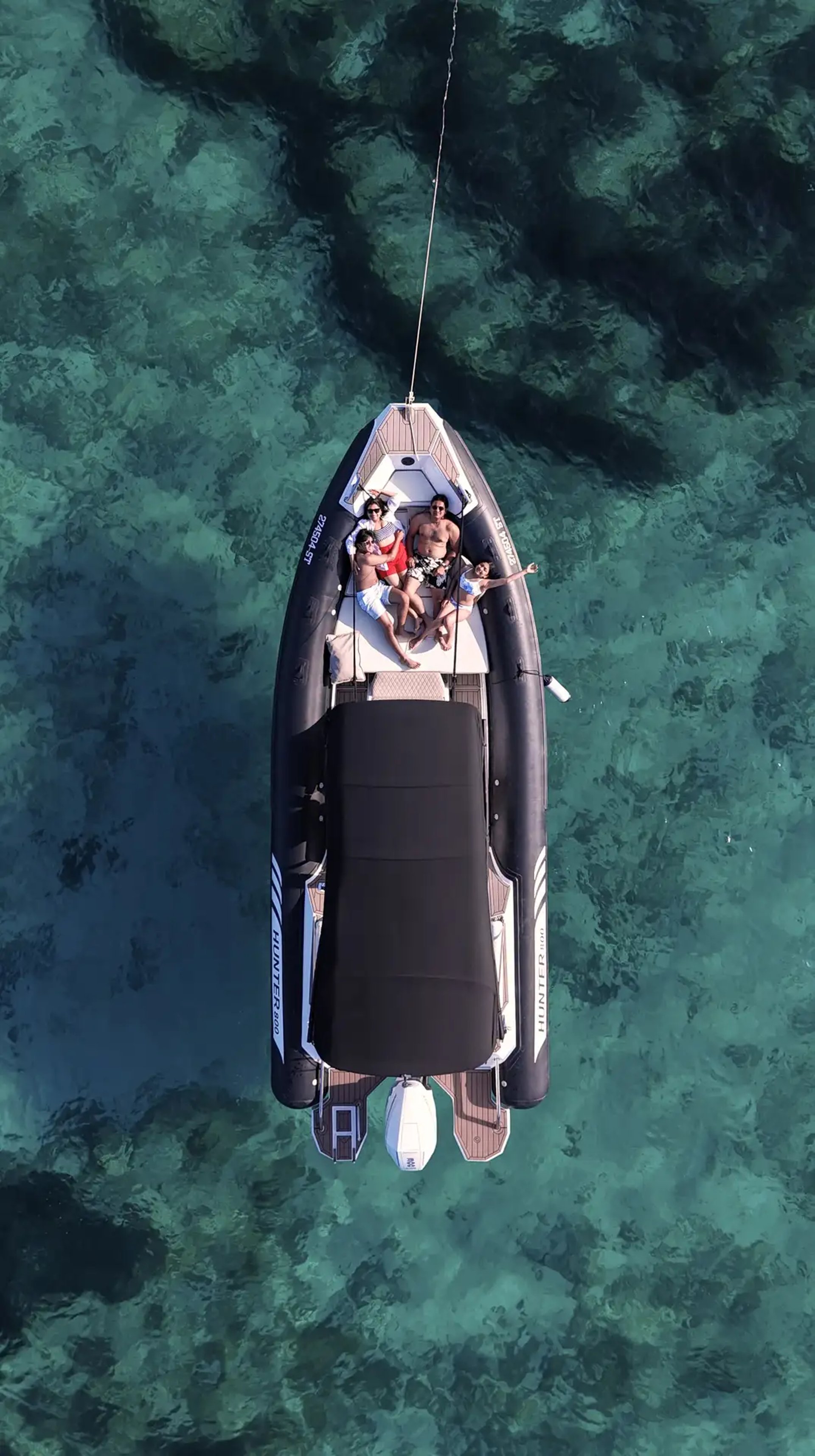Aerial of Hunter Pro 800 RIB with family on bow sundeck in turquoise Adriatic water during a private boat tour from Split.