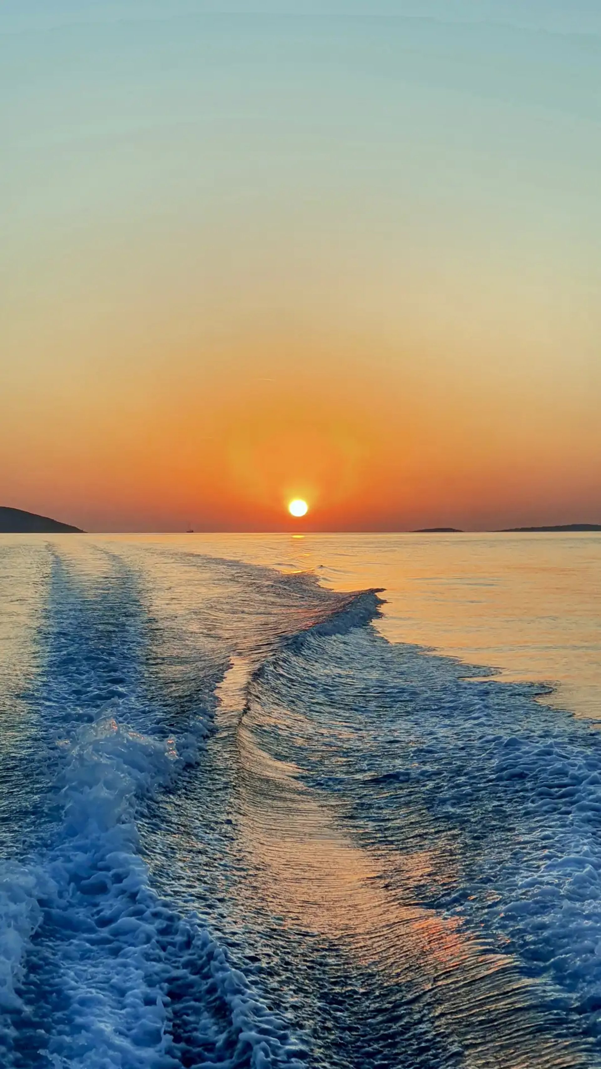 Powerful Adriatic sunset with boat wake and propulsion trail captured from a fast speedboat during a sunset tour