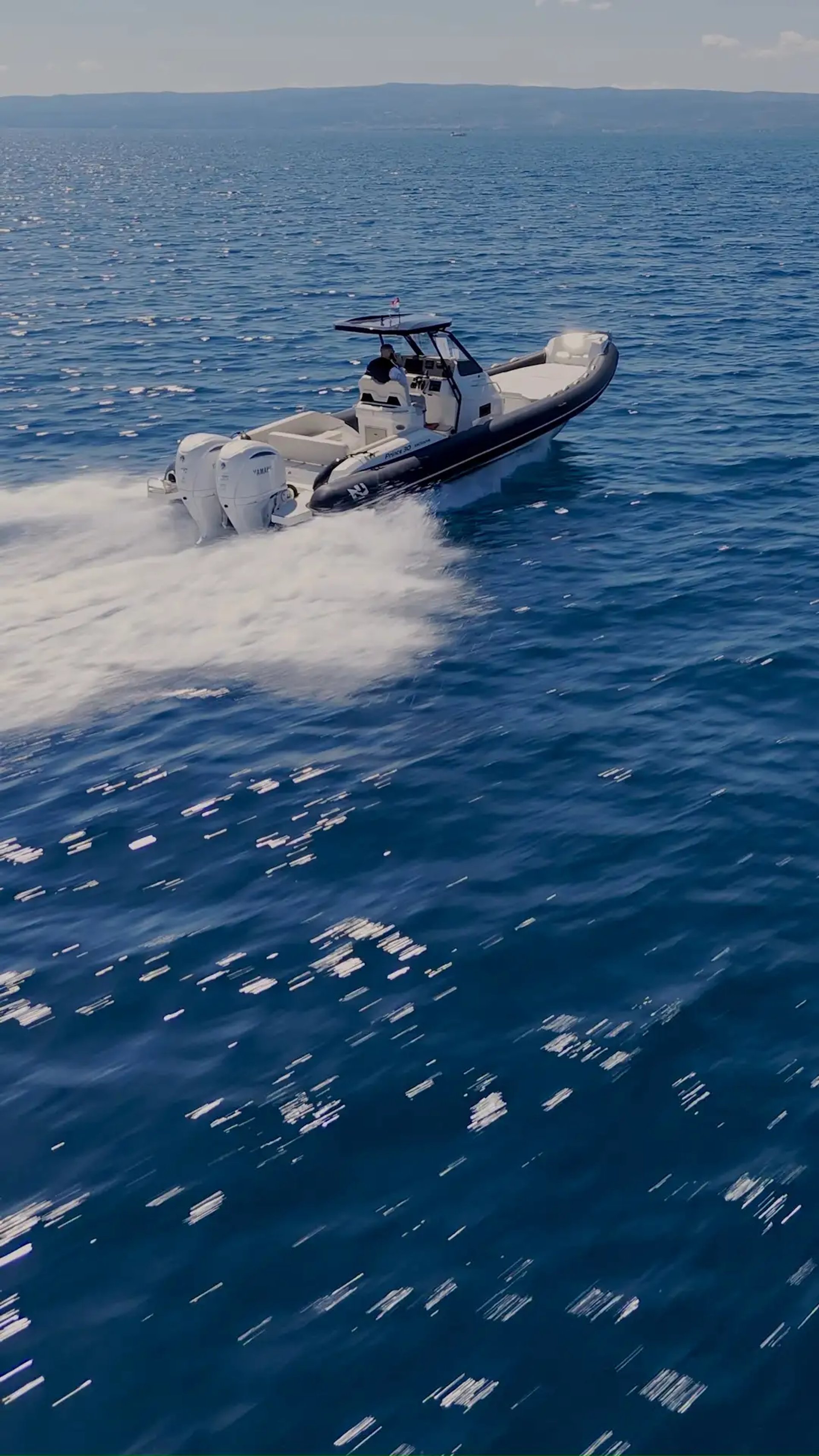 Drone view of Nuova Jolly Prince 30 Exclusive RIB slicing through the Adriatic Sea during a private boat transfer from Split