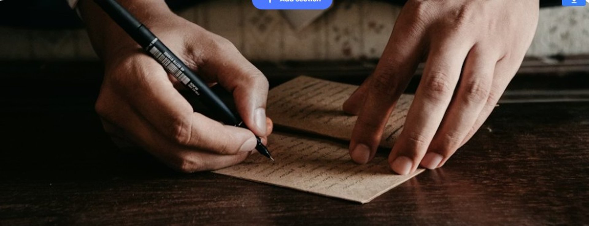 a person writing on a notebook with a pen