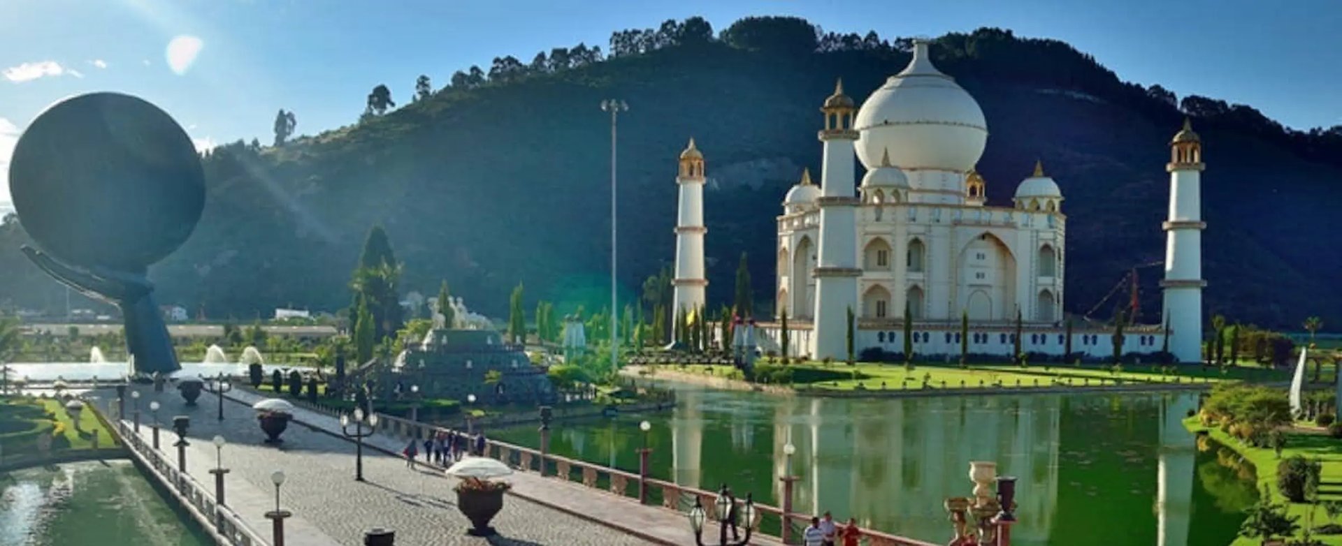 The iconic Taj Mahal monument and scenic lake inside Jaime Duque Park during a private day tour.