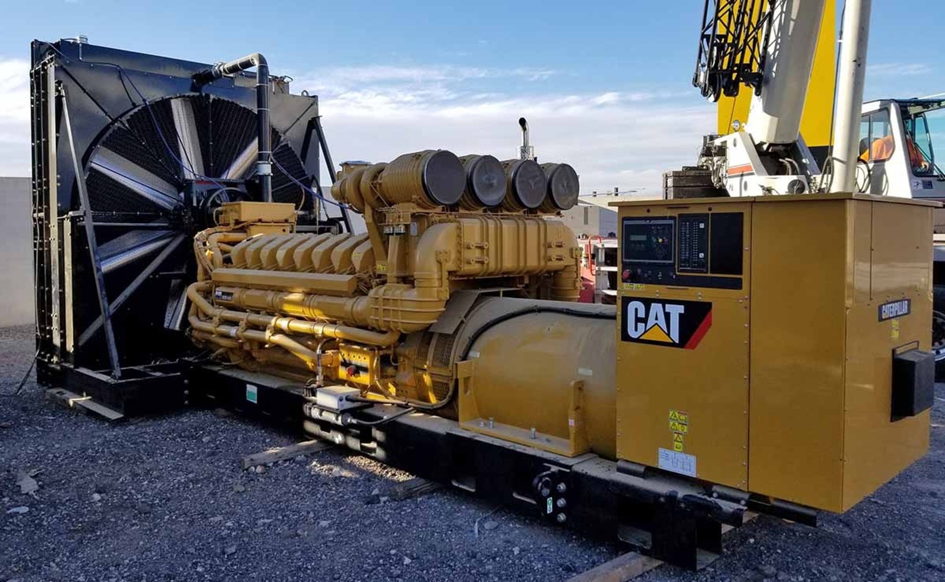 a yellow and black construction vehicle on a dirt road