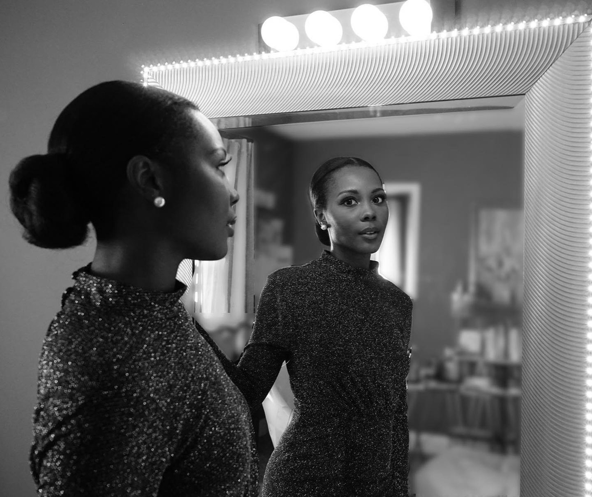 a woman in a white dress walking down a runway