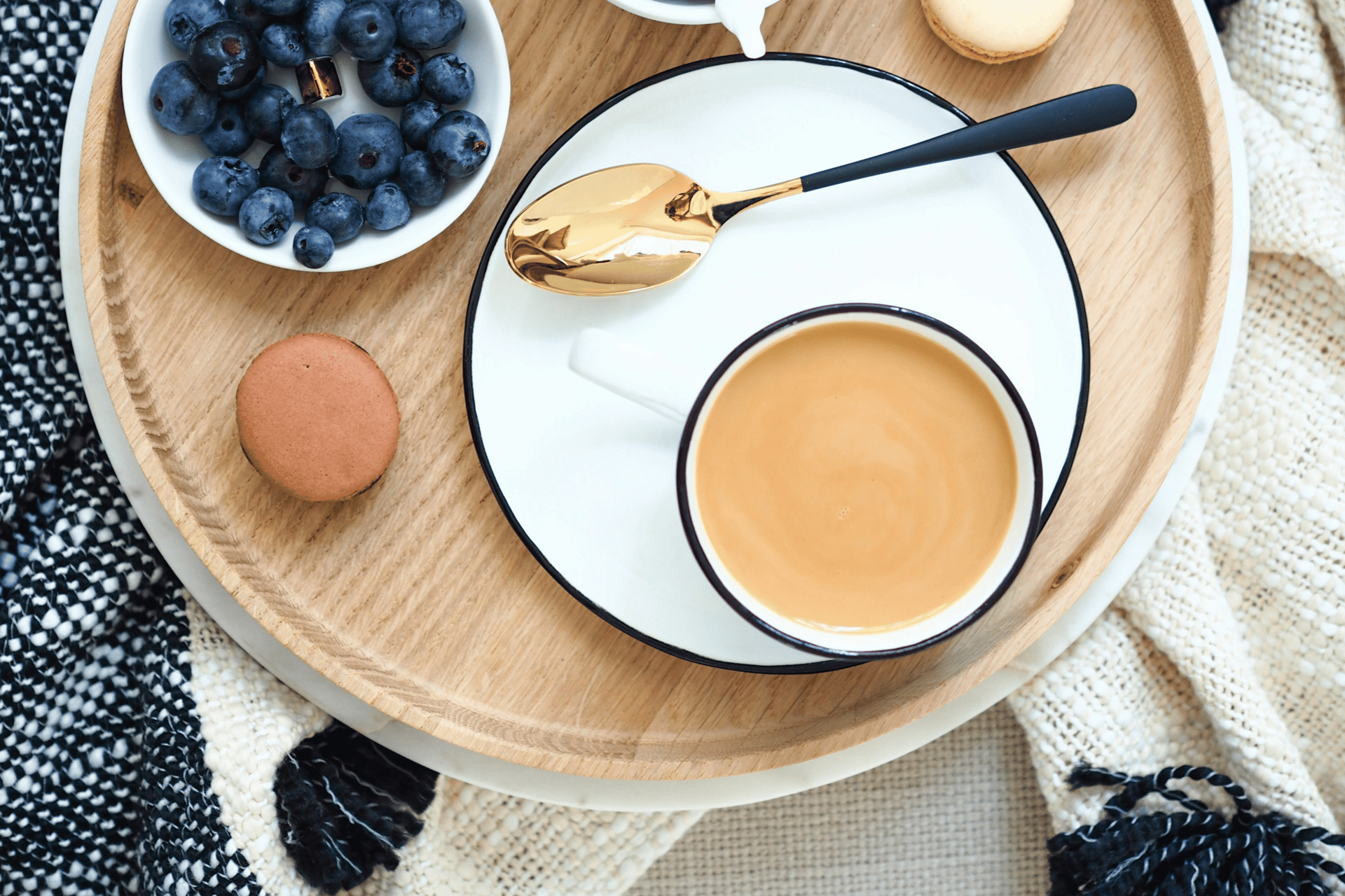 a breakfast tray with coffee, croissants, and croissants