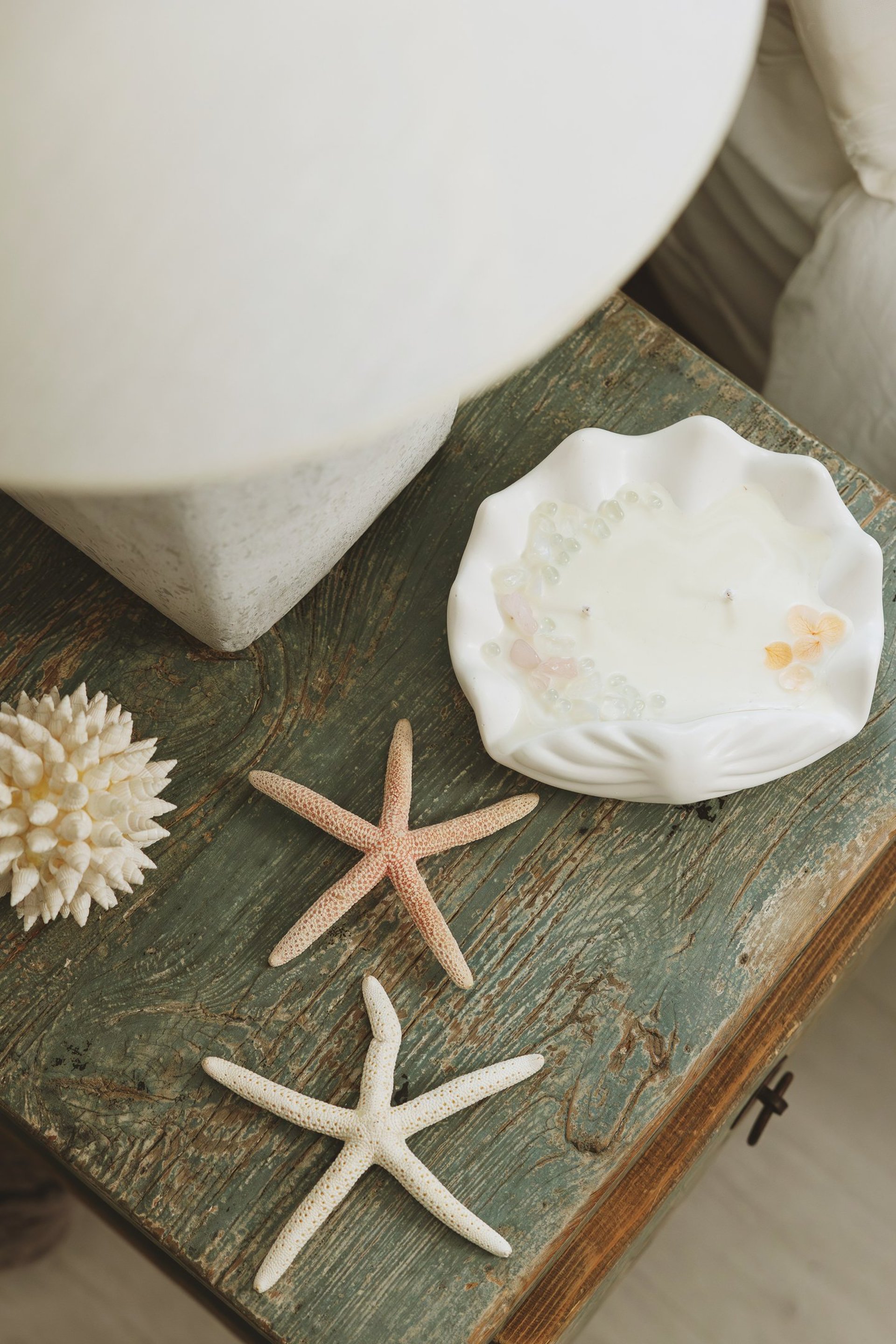 person holding white and black labeled glass jar