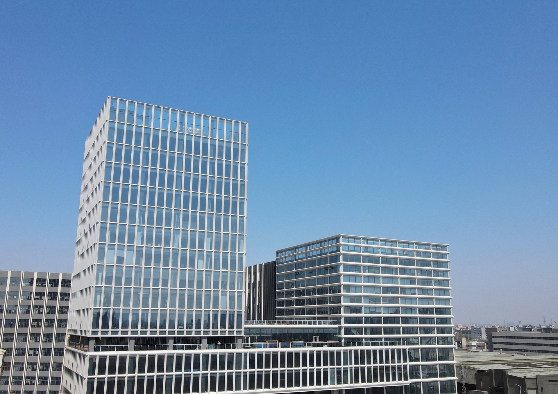 an abstract photo of a curved building with a blue sky in the background