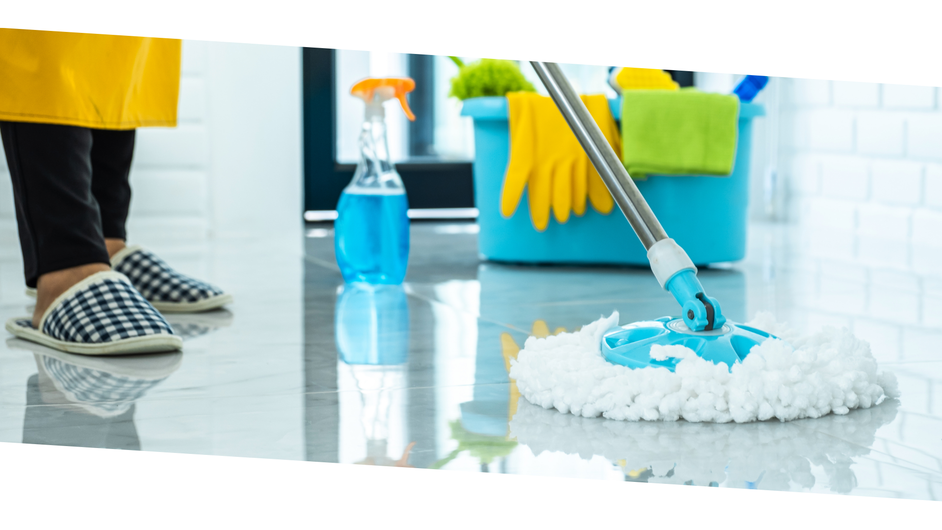 person in blue gloves holding white textile