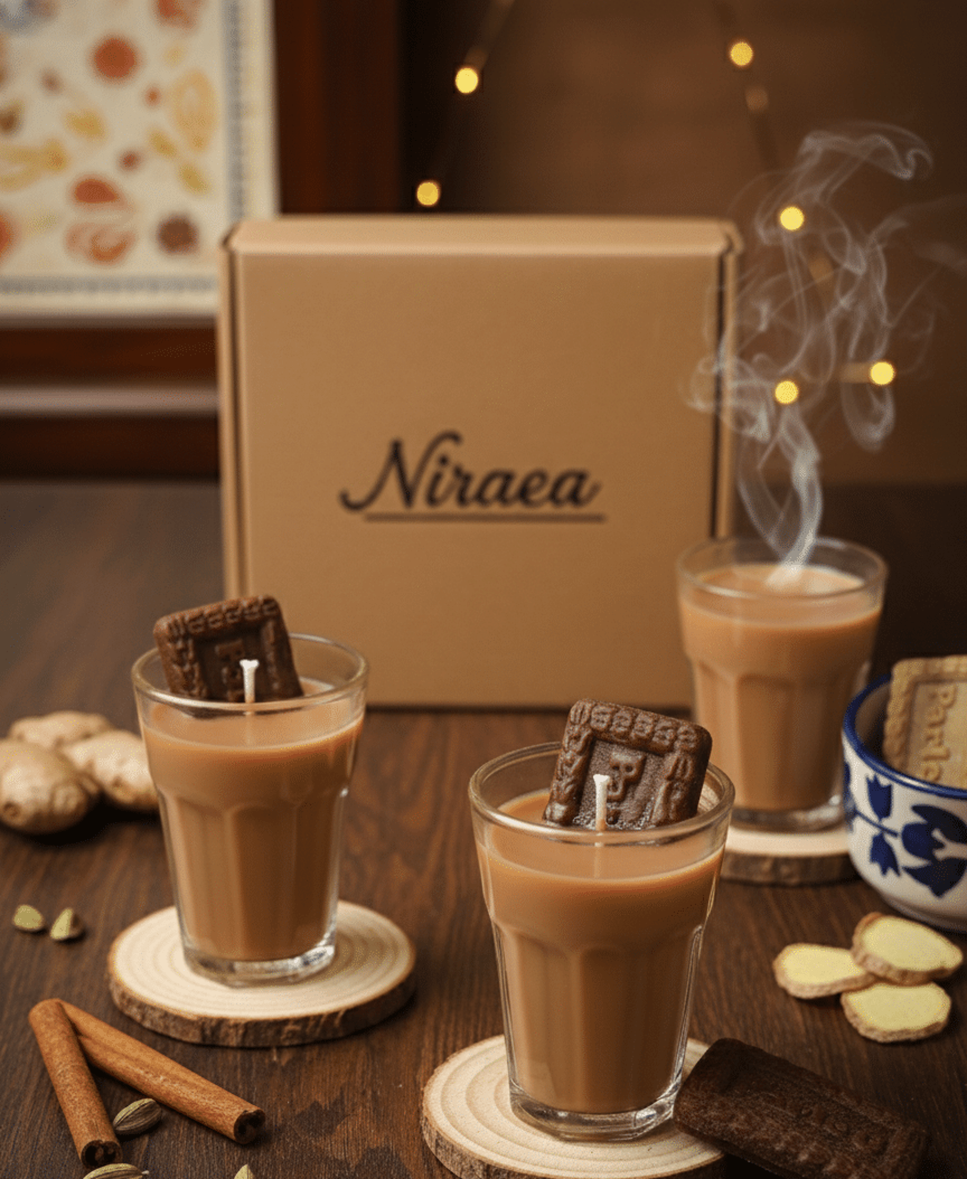 A candle sitting on top of a table next to a pine tree