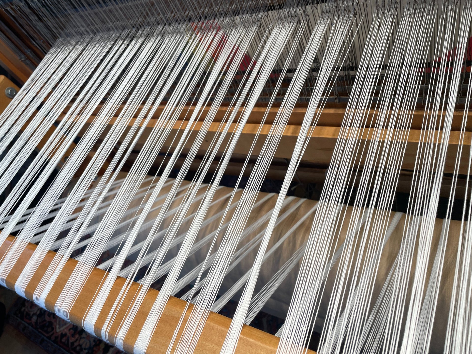 an abstract photo of a curved building with a blue sky in the background