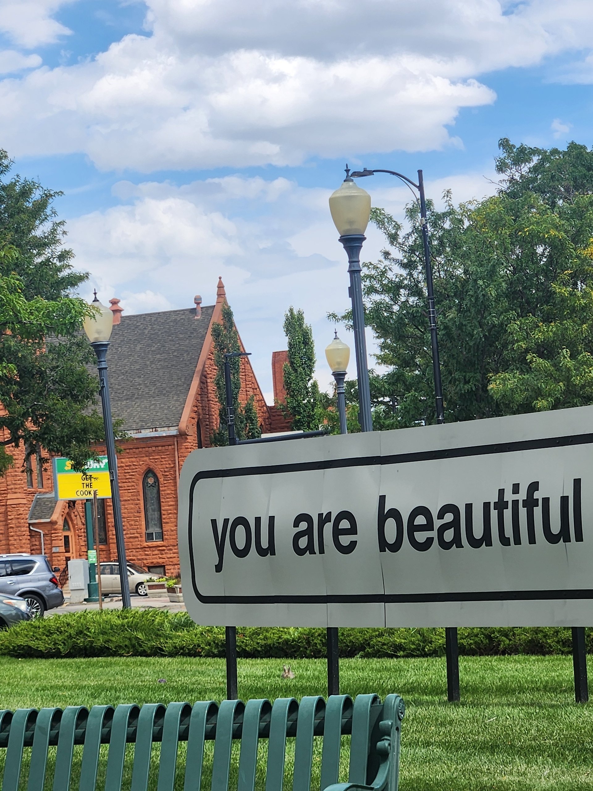 woman wearing yellow long-sleeved dress under white clouds and blue sky during daytime