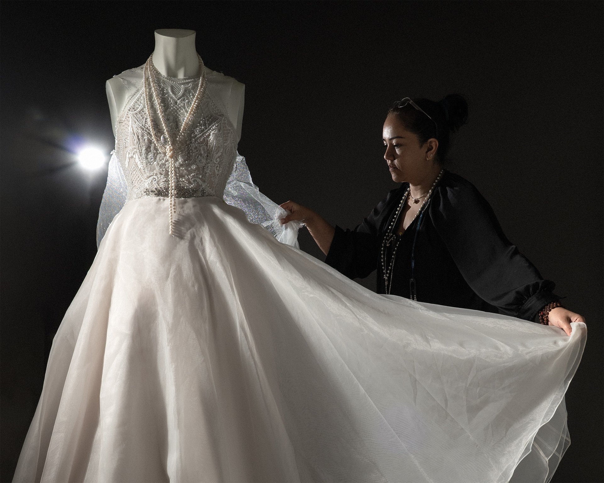 Young woman sewing by a window