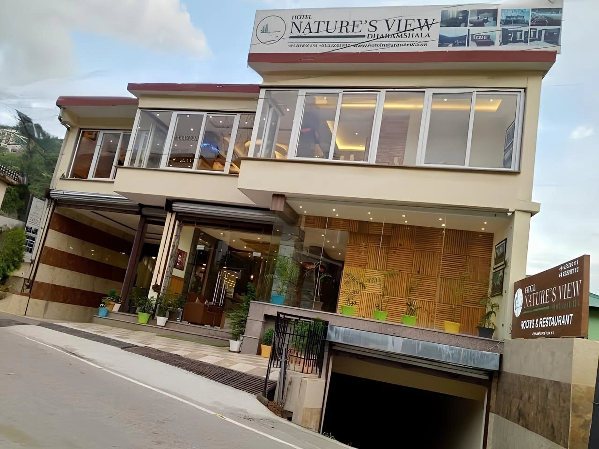 A cricket stadium with mountains in the background.