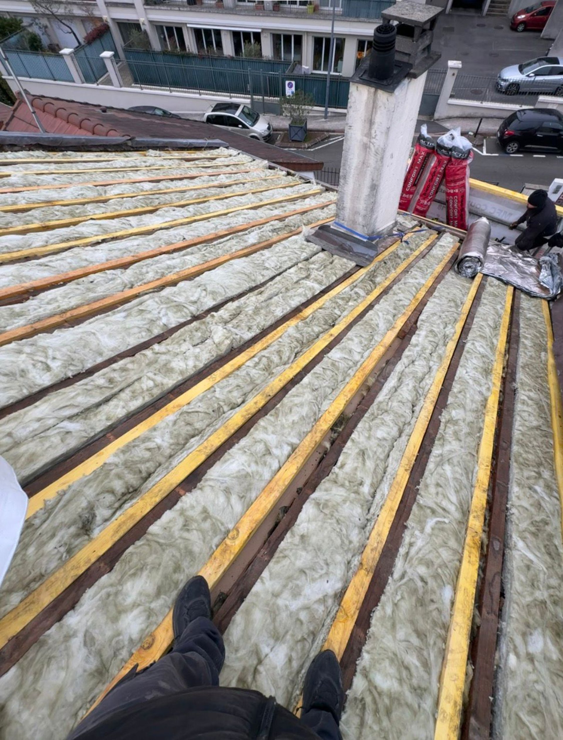 person in blue pants sitting on brown wooden floor