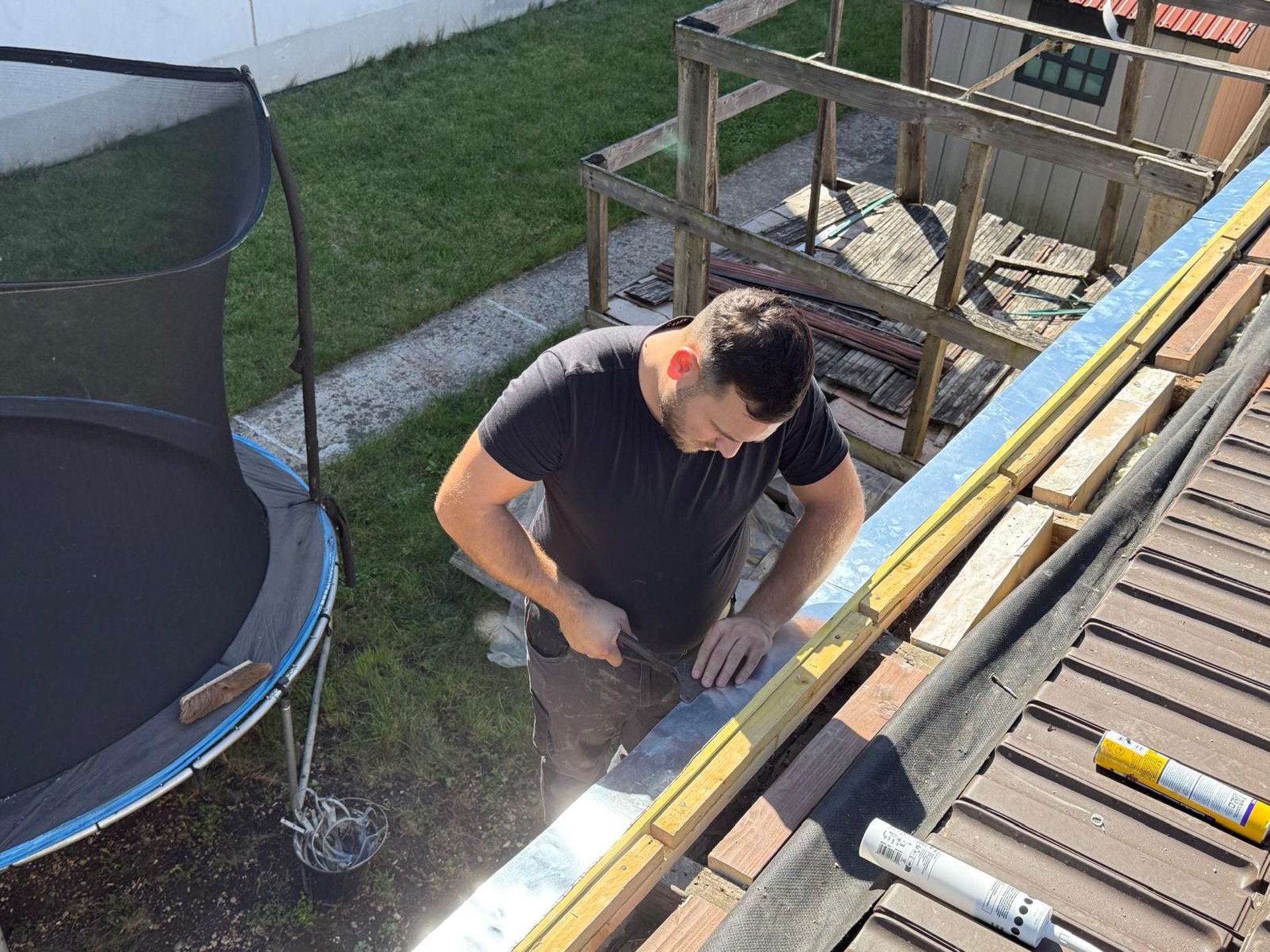 a person wearing blue gloves and holding a hammer