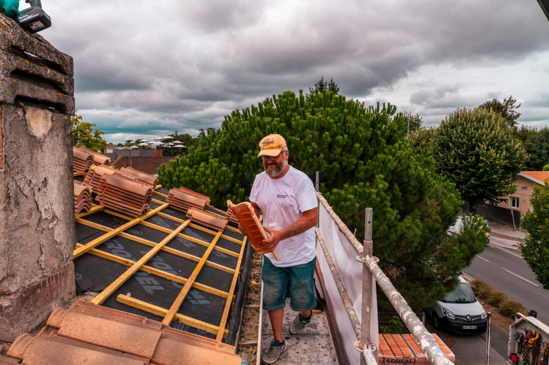 person in blue pants sitting on brown wooden floor