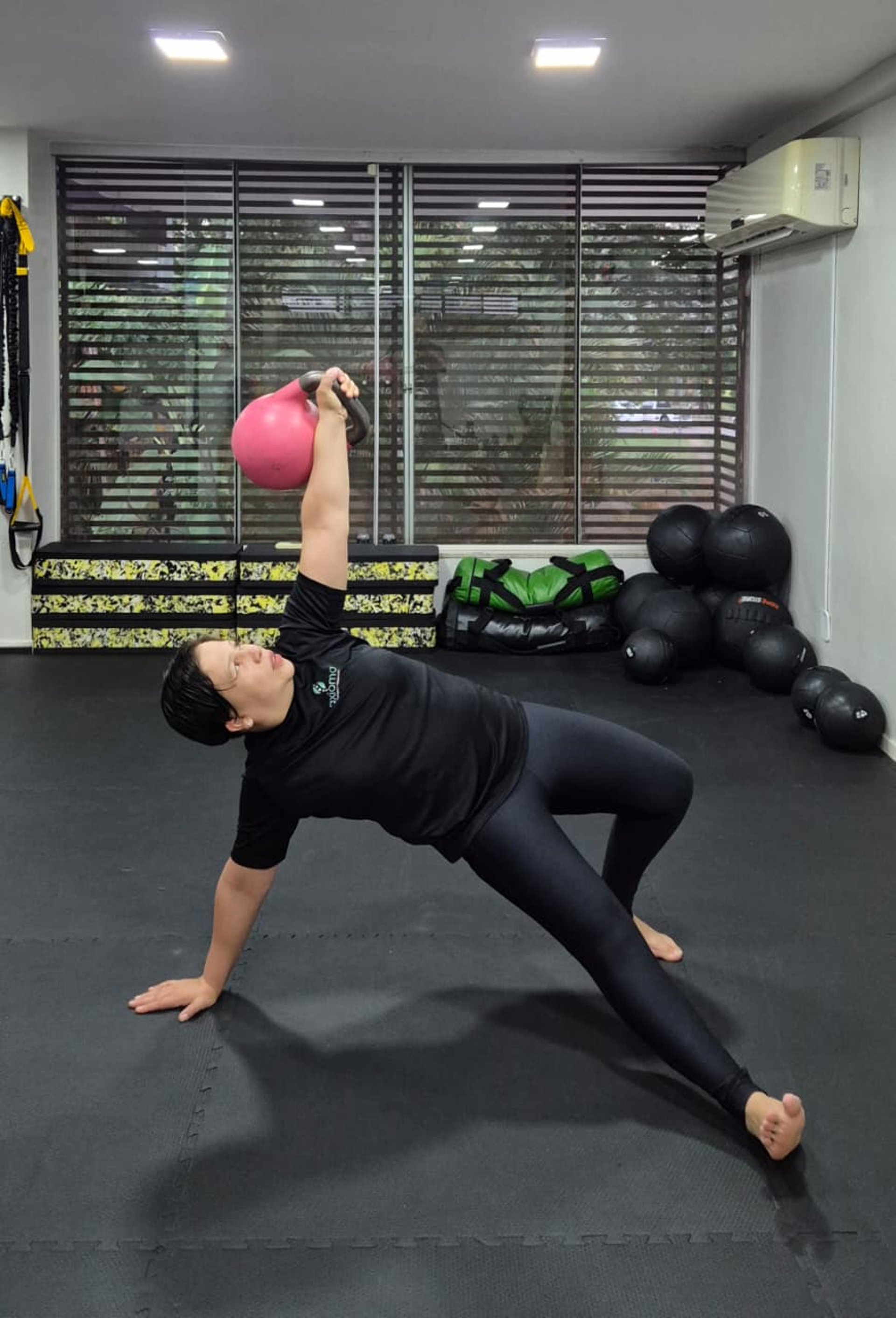 a woman is doing exercises on a rowing machine