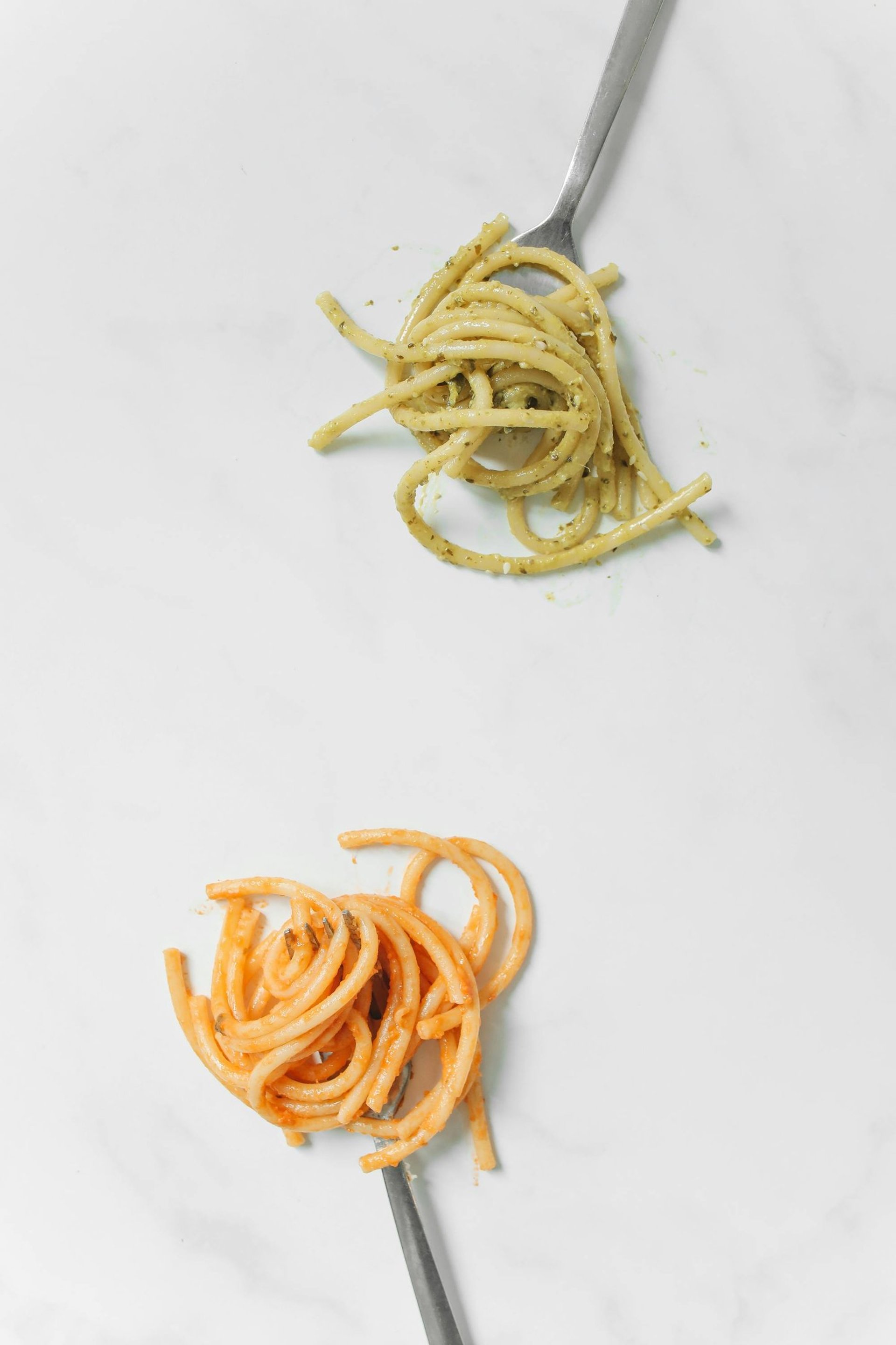 a white plate topped with spaghetti and tomatoes